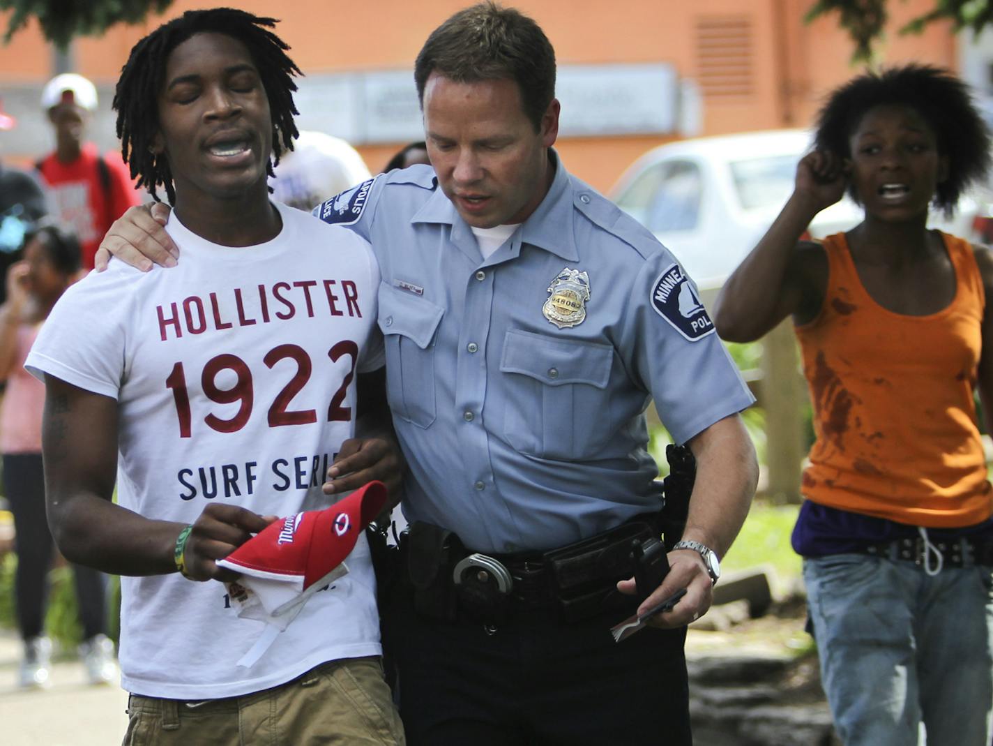 A Minneapolis police officer comforts a man who identified himself as a brother to the shooting victim in the 2900 block of Bloomington Ave. S. Friday, June 1, 2012. The victim had left the scene.] (DAVID JOLES/STARTRIBUNE) djoles@startribune.com A shooting took place in the 2900 block of Bloomington Ave. S. in which the victim left the scene Friday, June 1, 2012, in , Minneapolis MN.