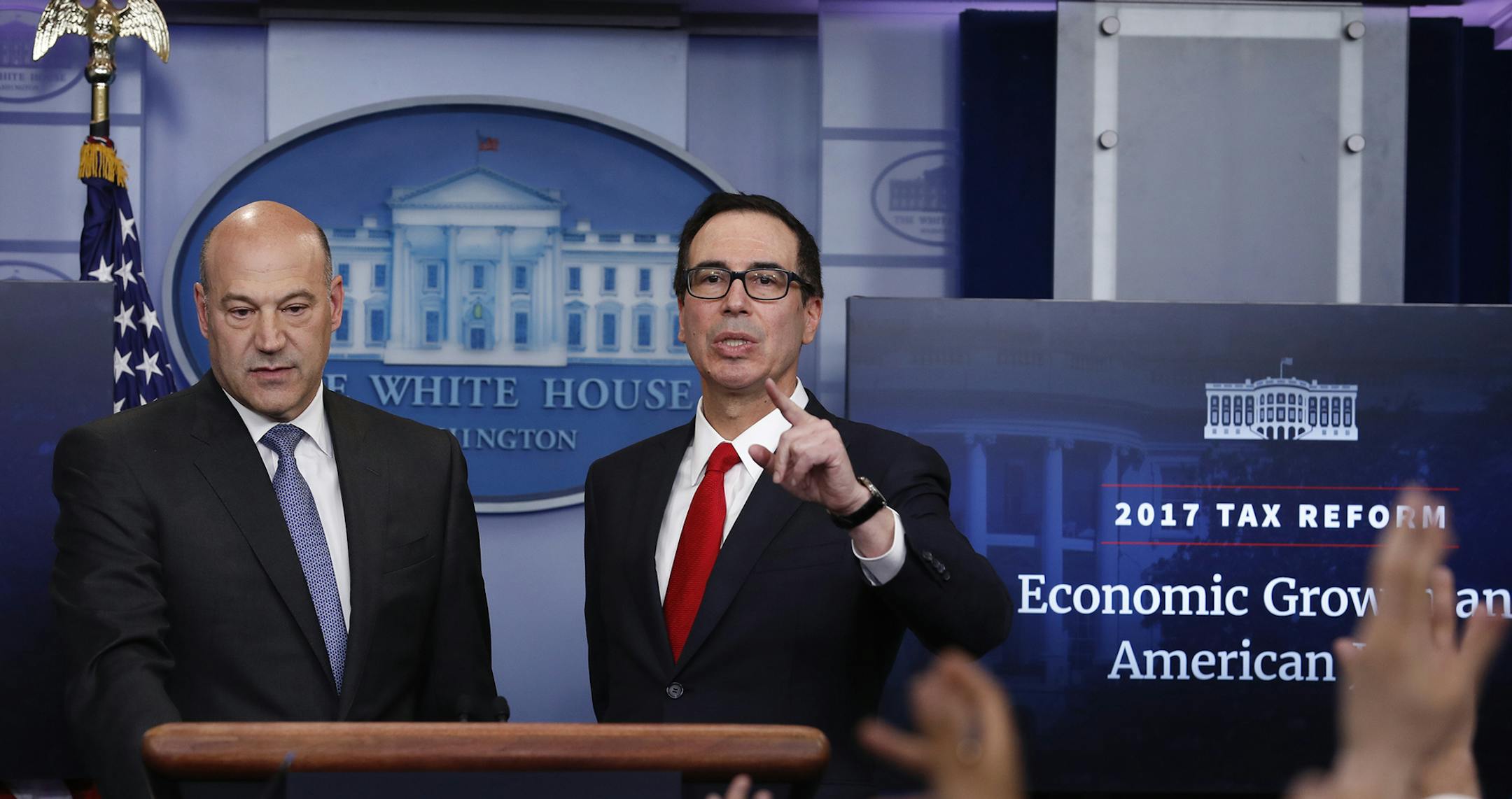 Treasury Secretary Steven Mnuchin, joined by National Economic Director Gary Cohn, speaks in the briefing room of the White House in Washington, Wednesday, April 26, 2017. President Donald Trump is proposing dramatically reducing the taxes paid by corporations big and small in an overhaul his administration says will spur economic growth and bring jobs and prosperity to the middle class. (AP Photo/Carolyn Kaster) ORG XMIT: MIN2017042615125824