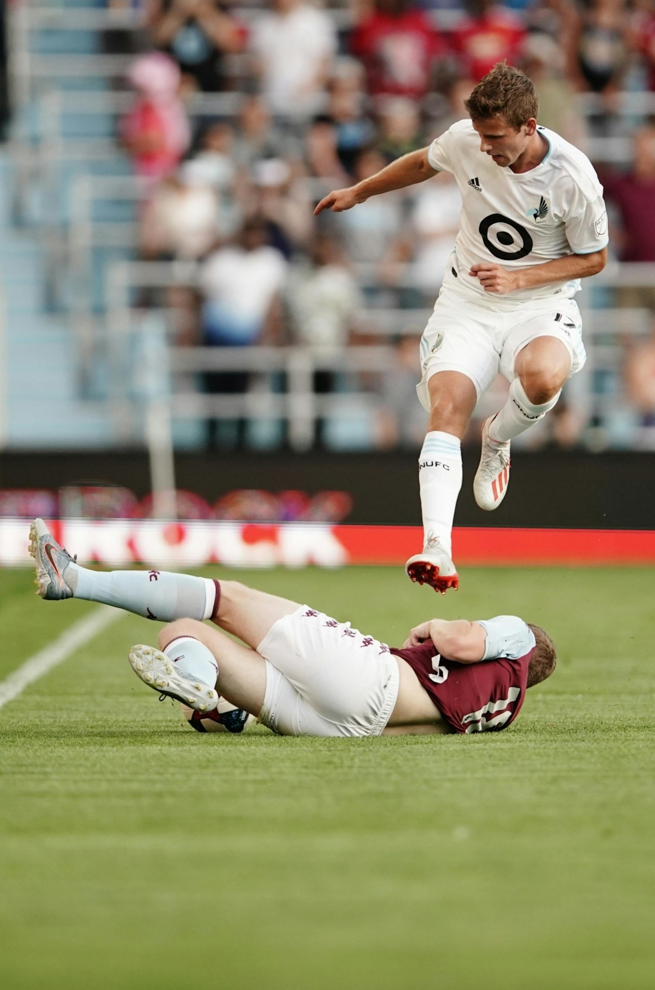 Aston Villa forward Tammy Abraham (18) kicked the ball out from under Minnesota United midfielder Collin Martin (17). Aston Villa and the Minnesota United remained tied 0-0 at the end of the first half.