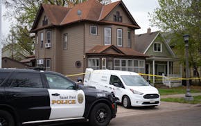 St. Paul Police and medical examiner vehicles are parked outside a home on Edmund Ave. in St. Paul on Friday. A homicide investigation is ongoing at t