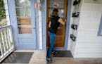Minneapolis resident Janne Flisrand on the front porch of her fourplex. Minneapolis planners had proposed a long-range plan allowing fourplexes citywi