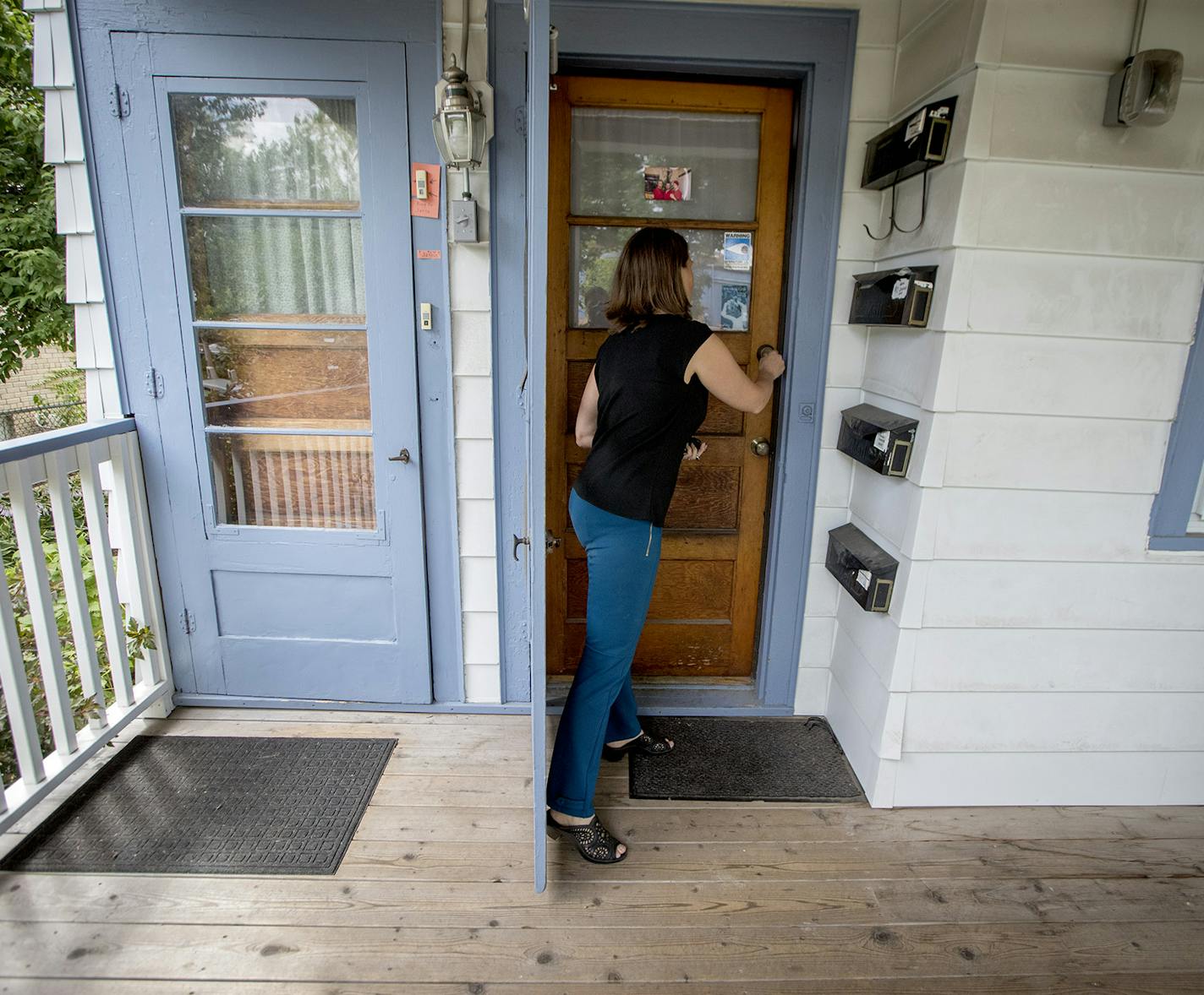 Minneapolis resident Janne Flisrand on the front porch of her fourplex. Minneapolis planners had proposed a long-range plan allowing fourplexes citywide, but are scaling that back after criticism.