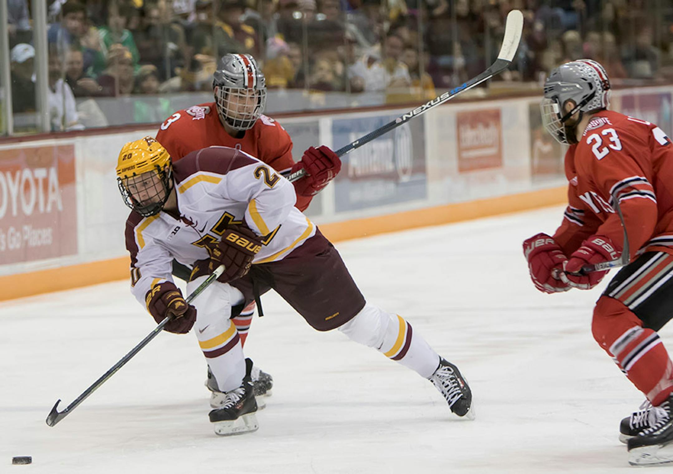 Minnesota Golden Gophers defenseman Michael Brodzinski (20) splits the defense of Ohio State Buckeyes defenseman Sasha Larocque (3) and Ohio State Buckeyes forward Tyler Lundey (23) as the Minnesota Golden Gophers hosted the Ohio State Buckeyes to open the Big Ten Conference schedule on December 4, 2015. ] Special to Star Tribune MATT BLEWETT ï matt@mattebphoto.com - December 4, 2015, Minneapolis, MN, Big Ten Hockey, Minnesota Golden Gophers vs. Ohio State Buckeyes, 257622 UPUK 120415
