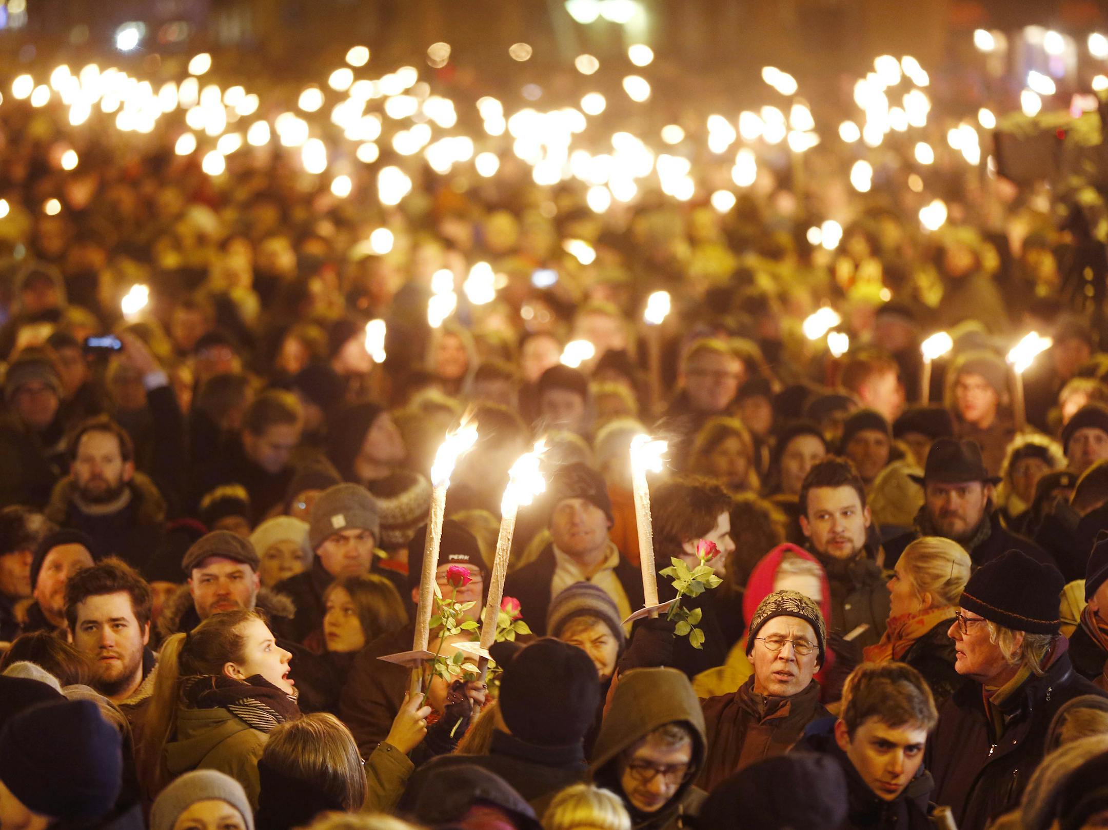 Hundreds of people gather for a vigil near the cultural club in Copenhagen, Denmark, Monday, Feb. 16, 2015. The slain gunman behind two deadly shooting attacks in Copenhagen was released from jail just two weeks ago and might have become radicalized there last summer, a source close to the Danish terror investigation told The Associated Press on Monday. The prime ministers of Denmark and Sweden were expected to join thousands of people at memorials in Copenhagen on Monday evening. (AP Photo/Mich