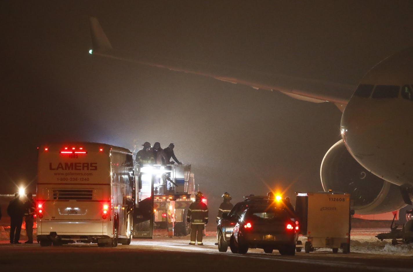 Vikings players were getting off the their plane two at a time via a cherry picker operated by a firefighter after their chartered aircraft got stuck in snow after landing at Appleton International Airport.