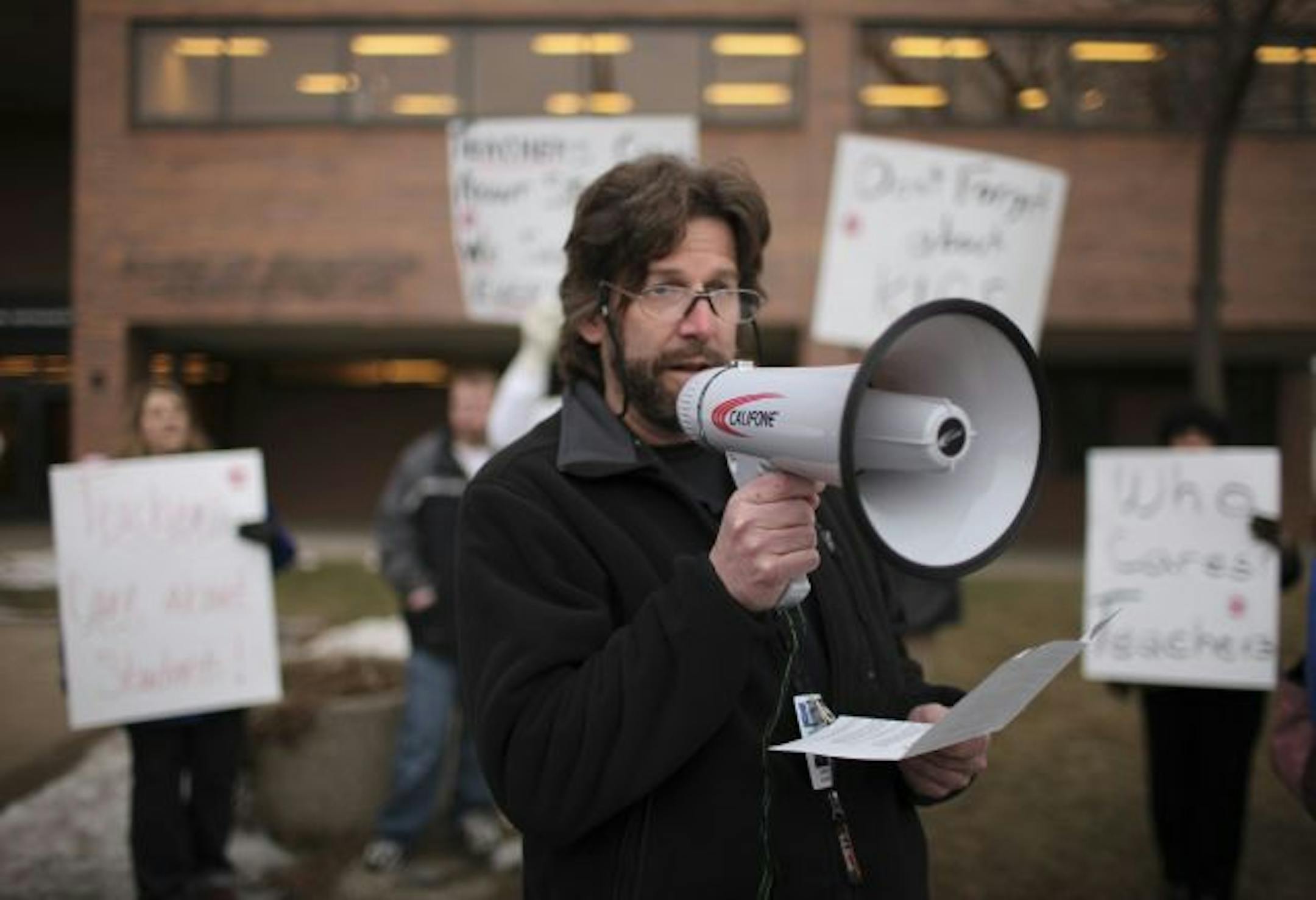 Jim Evans, a staffer at Arlington High School, addressed the rally outside the school district offices Tuesday evening in St. Paul.