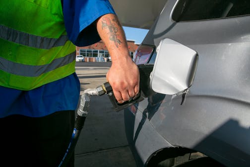 A gas station employee pumps gas into a vehicle at a Sunoco station in Wall Township, New Jersey, on the Garden State Parkway on Friday, July 22, 2022. (AP Photo/Ted Shaffrey)