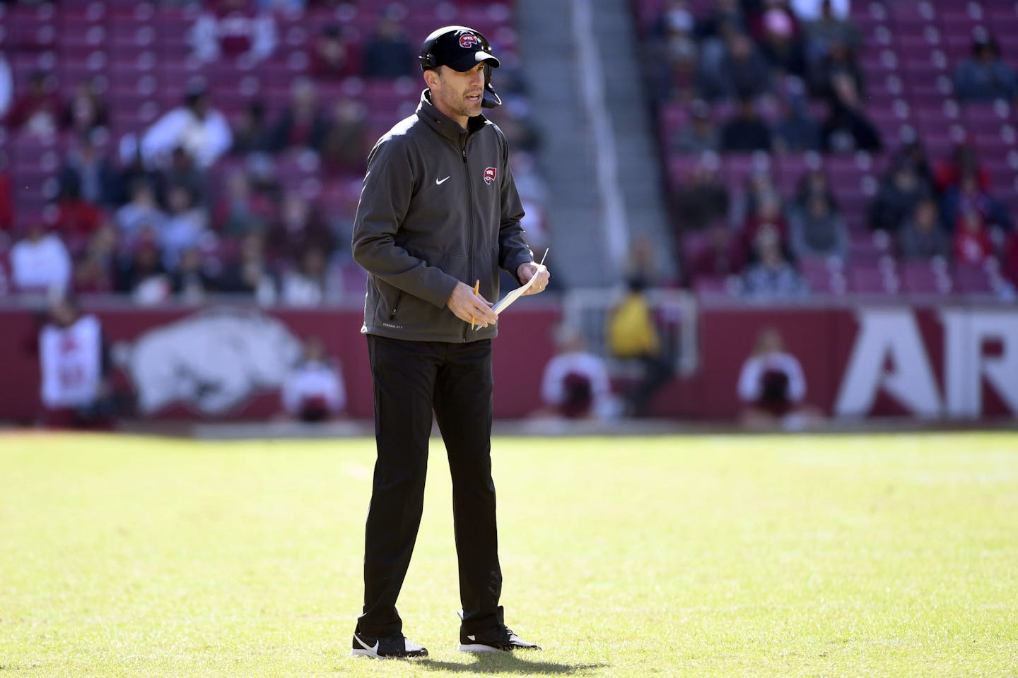 Western Kentucky coach Mike Sanford walks on the field during the second half of an NCAA college football game against Arkansas, Saturday, Nov. 9, 2019 in Fayetteville, Ark. (AP Photo/Michael Woods) ORG XMIT: ARMW123