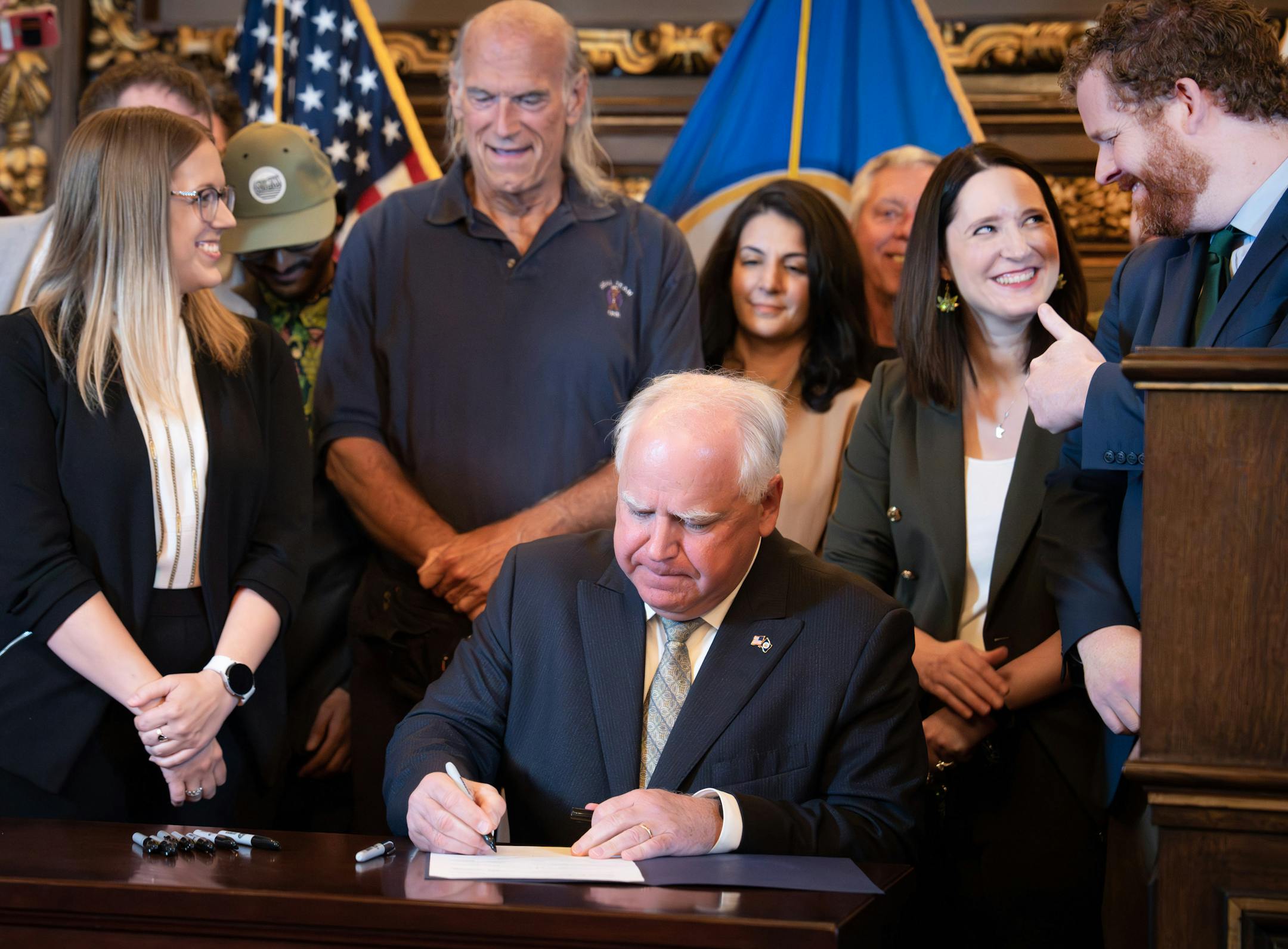 Bill sponsors Rep. Zack Stephenson, DFL-Coon Rapids, right, gave a thumbs up to Sen. Lindsey Port, DFL-Burnsville as Gov Walz signed the bill into law Tuesday, May 30, 2023 St. Paul, Minn. ] GLEN STUBBE • glen.stubbe@startribune.com