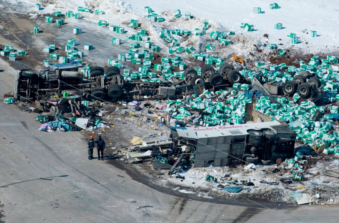 Emergency personnel work at the scene of a fatal crash outside of Tisdale, Saskatchewan, Canada, Saturday, April, 7, 2018. A bus en route to Nipawin, foreground, carrying the Humbolt Broncos junior hockey team crashed into a truck Friday night, killing 14 and sending over a dozen more to the hospital.(Jonathan Hayward/The Canadian Press via AP)