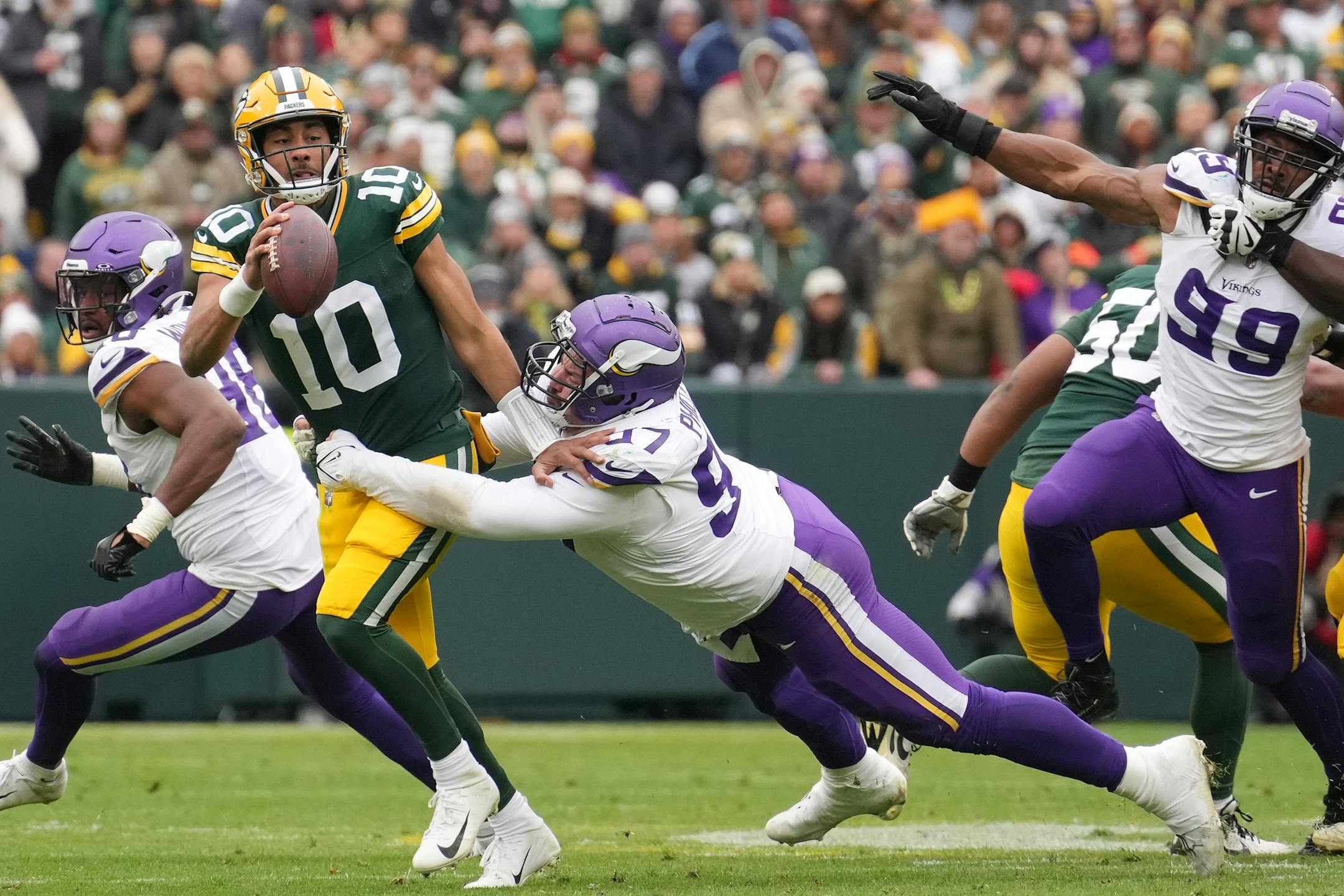 Minnesota Vikings defensive tackle Harrison Phillips (97) gets arms around Green Bay Packers quarterback Jordan Love (10) as he scrambles out of the pocket in the fourth quarter of an NFL game between the Minnesota Vikings and the Green Bay Packers Sunday, Oct. 29, 2023 at Lambeau Field in Green Bay, Wis. ] ANTHONY SOUFFLE • anthony.souffle@startribune.com