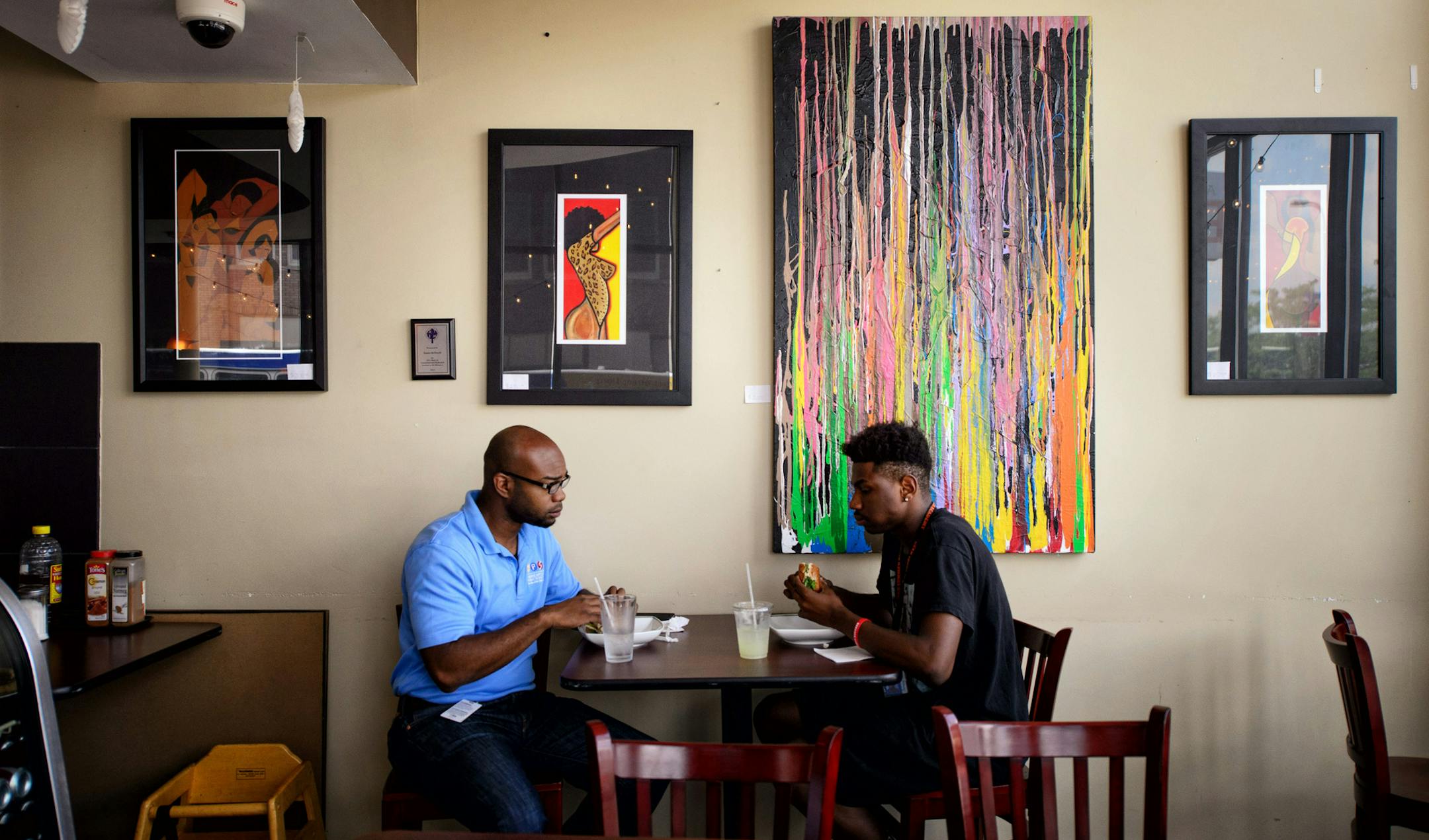 Cedrick Frazier and Tyrone Gill had lunch in the Avenue Eatery on West Broadway where some of the artwork fir the show is displayed. ] GLEN STUBBE * gstubbe@startribune.com Friday, July 10, 2015 The Flow Northside Arts Crawl, in its tenth year, showcases the growing arts scene in North Minneapolis. Advancing the 7/23 festival. Artistic director Dudley Voight will take us on a tour of murals and galleries along West Broadway -She will take us to a deli where a local artist is putting up new work,