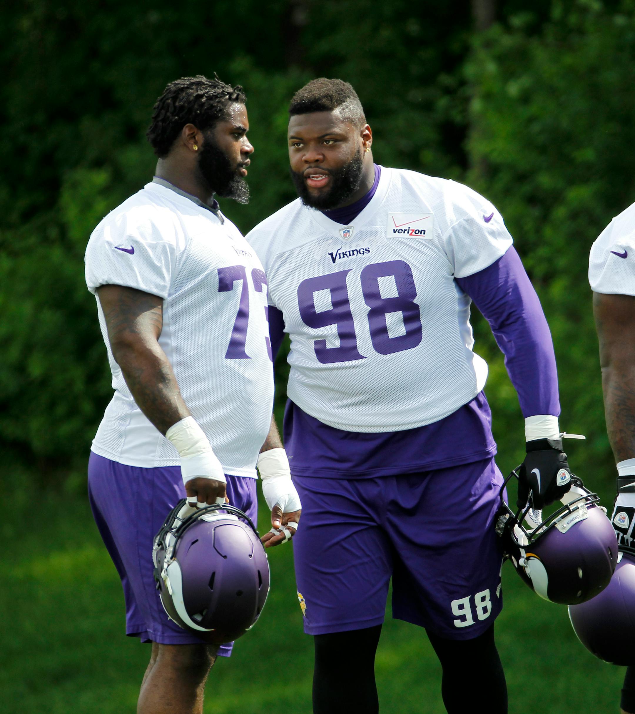 Minnesota Vikings defensive tackle Linval Joseph (98) talks with Sharrif Floyd during an NFL organized team activity in Eden Prairie, Minn., Thursday, June 5, 2014. (AP Photo/Ann Heisenfelt)