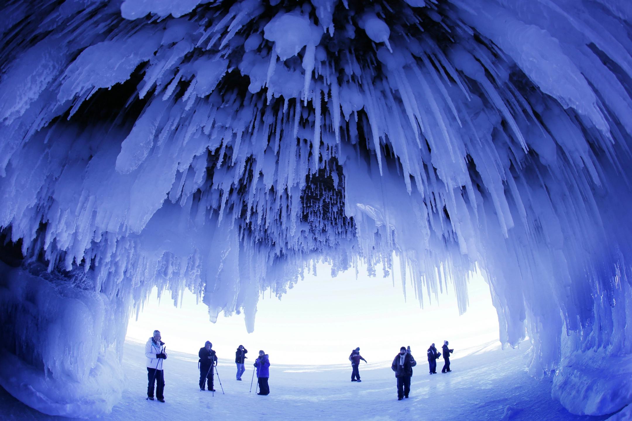 FILE - In this Feb. 2, 2014 file photo, people visit the caves at Apostle Islands National Lakeshore in northern Wisconsin, transformed into a dazzling display of ice sculptures by the arctic siege gripping the Upper Midwest.