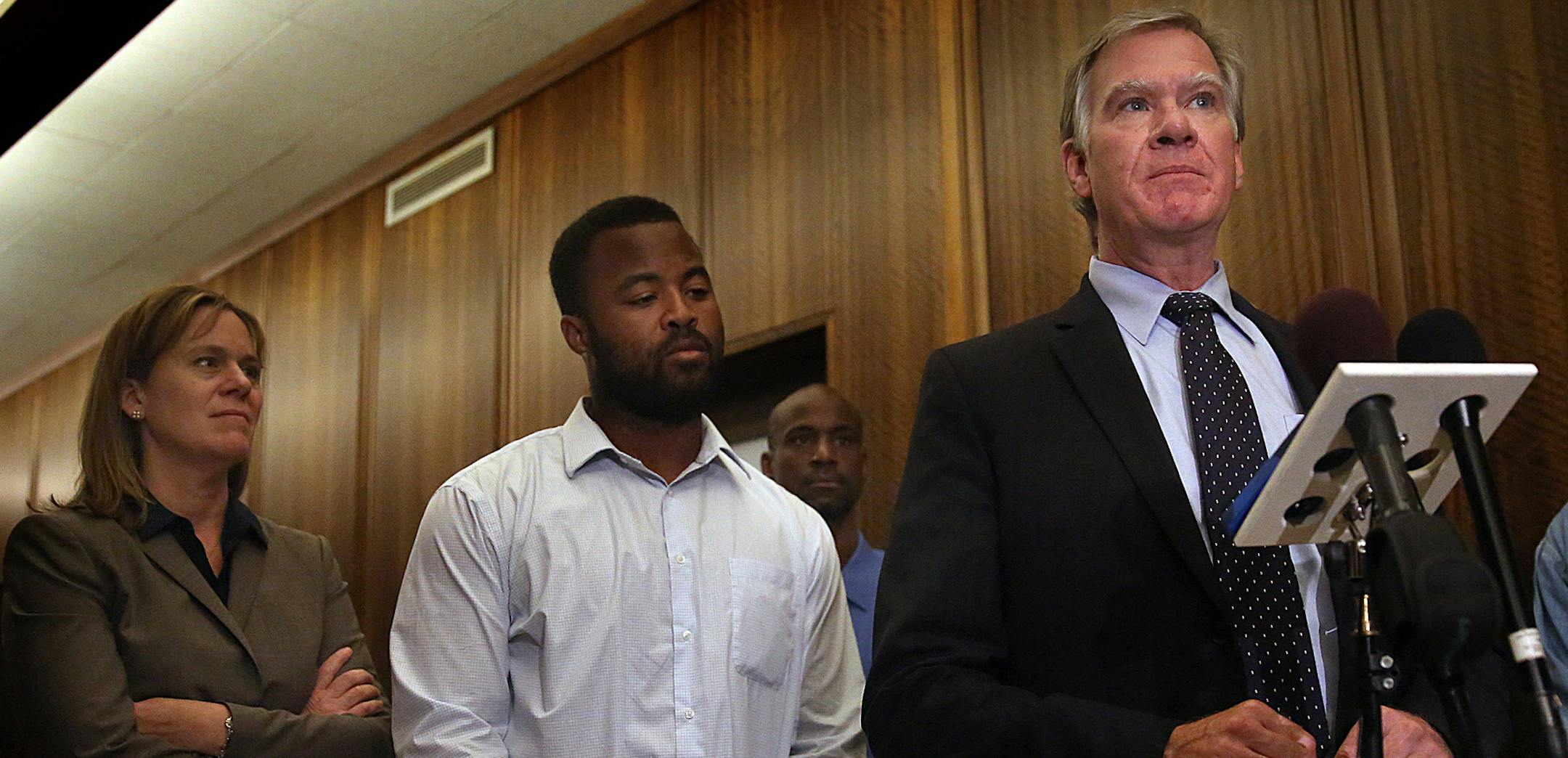 Rashad Turner, second from left, the leader of the St. Paul chapter of Black Lives Matter, joins St. Paul Mayor Chris Coleman, right, and Saint Paul Deputy Mayor, Kristin Beckmann during a news conference following a meeting Thursday morning, Oct. 1, 2015, at the mayor&#xed;s office in St. Paul, Minn. The St. Paul chapter's plan to protest at the Twin Cities Marathon has sparked division and raised alarm among an estimated 11,000 runners about potential conflicts at the finish line. Turner says