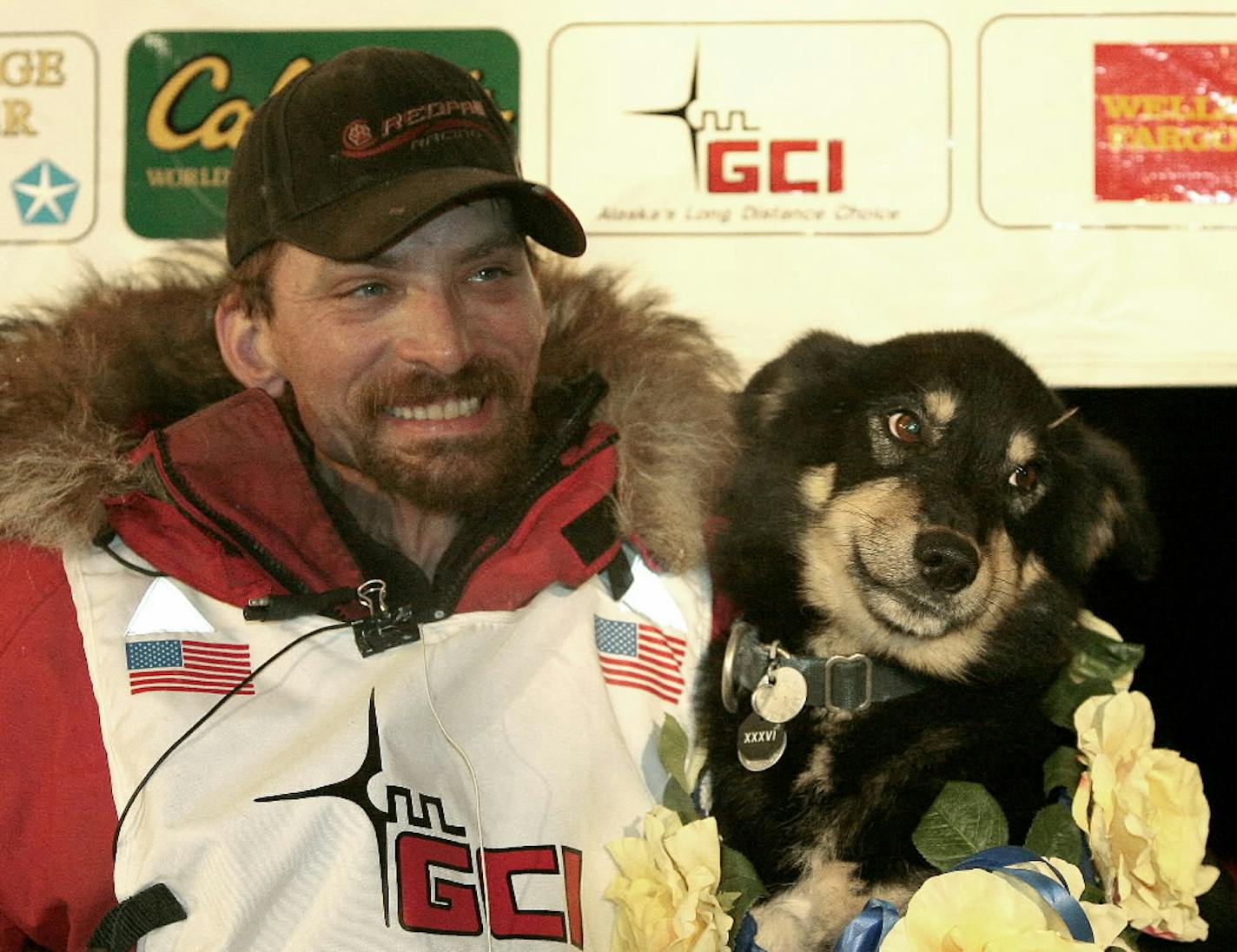 Lance Mackey sits with one of his dogs, Handsome, after winning the Iditarod Trail Sled Dog Race in Nome, Alaska early today.