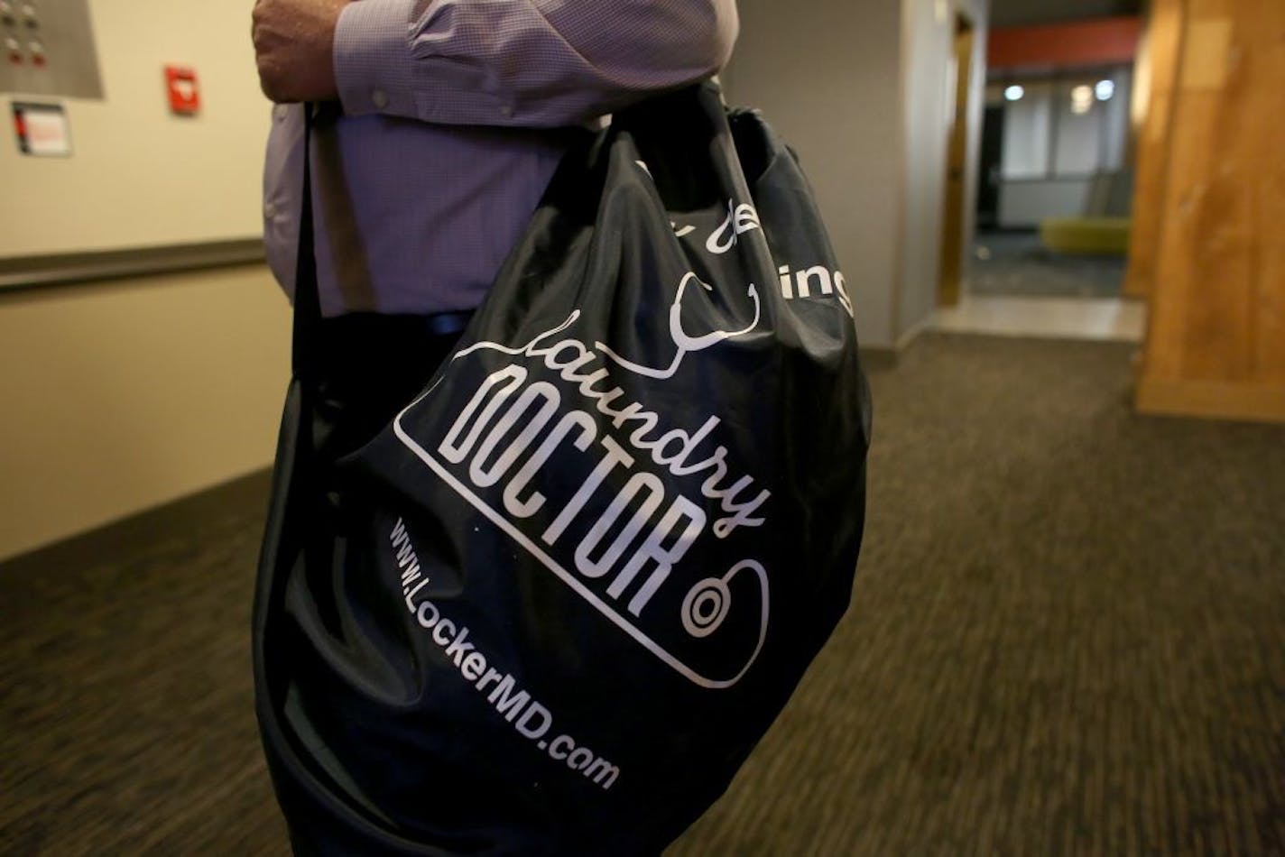 Jeff Gardner, of Laundry Doctor, sported one of the bags clients can drop off dirty laundry and pick it up 48 hours later.