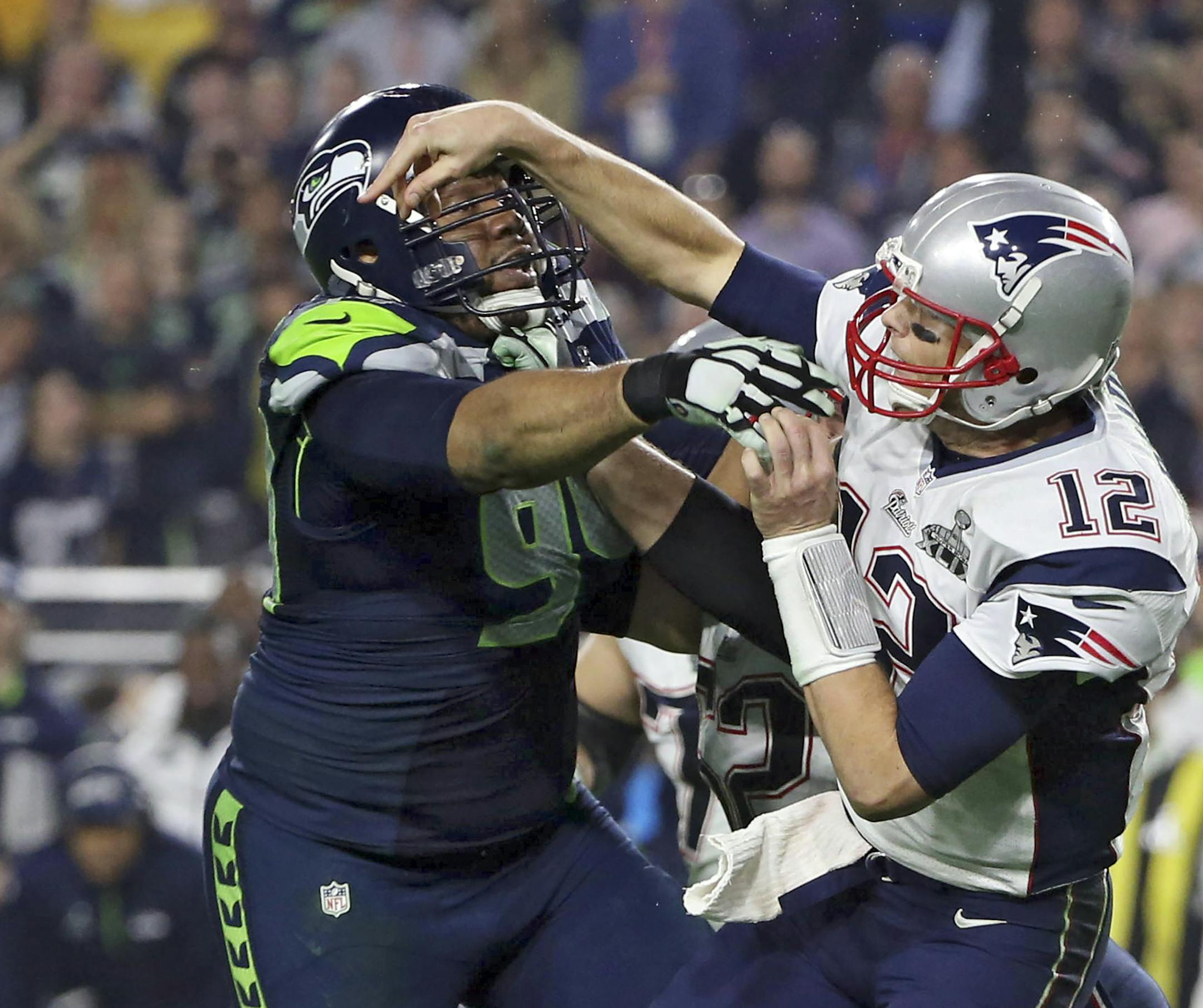 Seattle Seahawks defensive tackle Kevin Williams (94) pressures New England Patriots quarterback Tom Brady (12) as he throws during the second half of Super Bowl XLIX at University of Phoenix Stadium in Glendale, Ariz., Feb. 1, 2015. (Doug Mills/The New York Times)