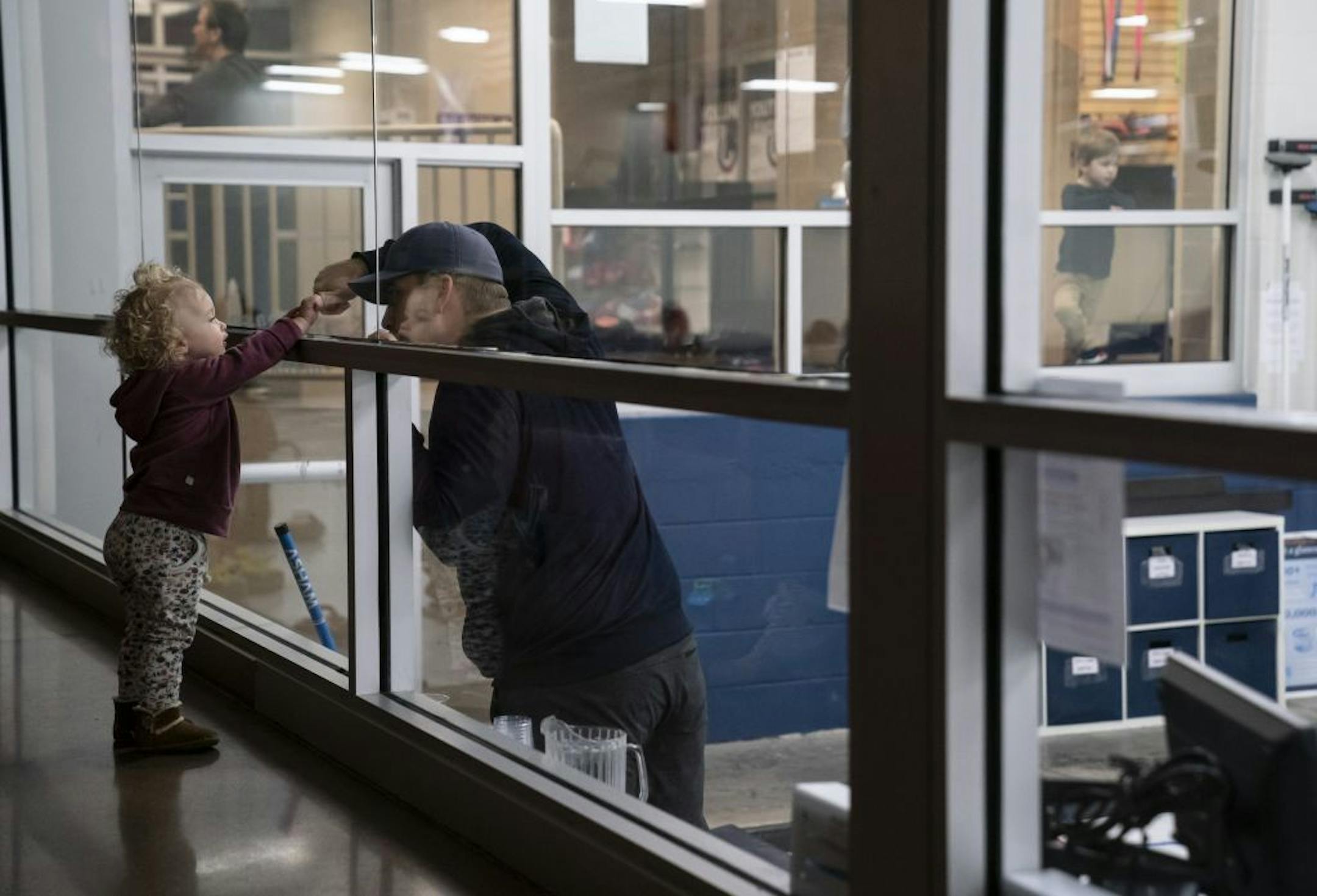 Tom Ryan gave his daughter Emily a fist pump through the restaurant glass as he played in his curling league at the Four Seasons Curling Club in Blaine, Minn., Wednesday, January 29, 2020.