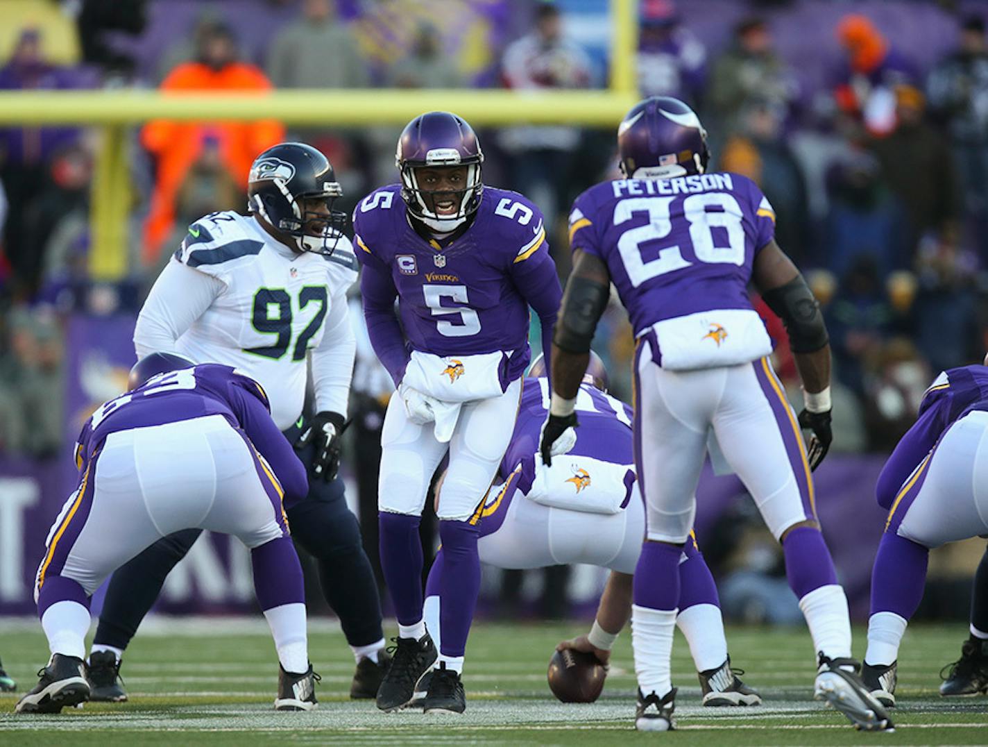 Vikings quarterback Teddy Bridgewater (5) gave the play call to Vikings running back Adrian Peterson (28) in the third quarter of the Vikings-Seattle playoff game.