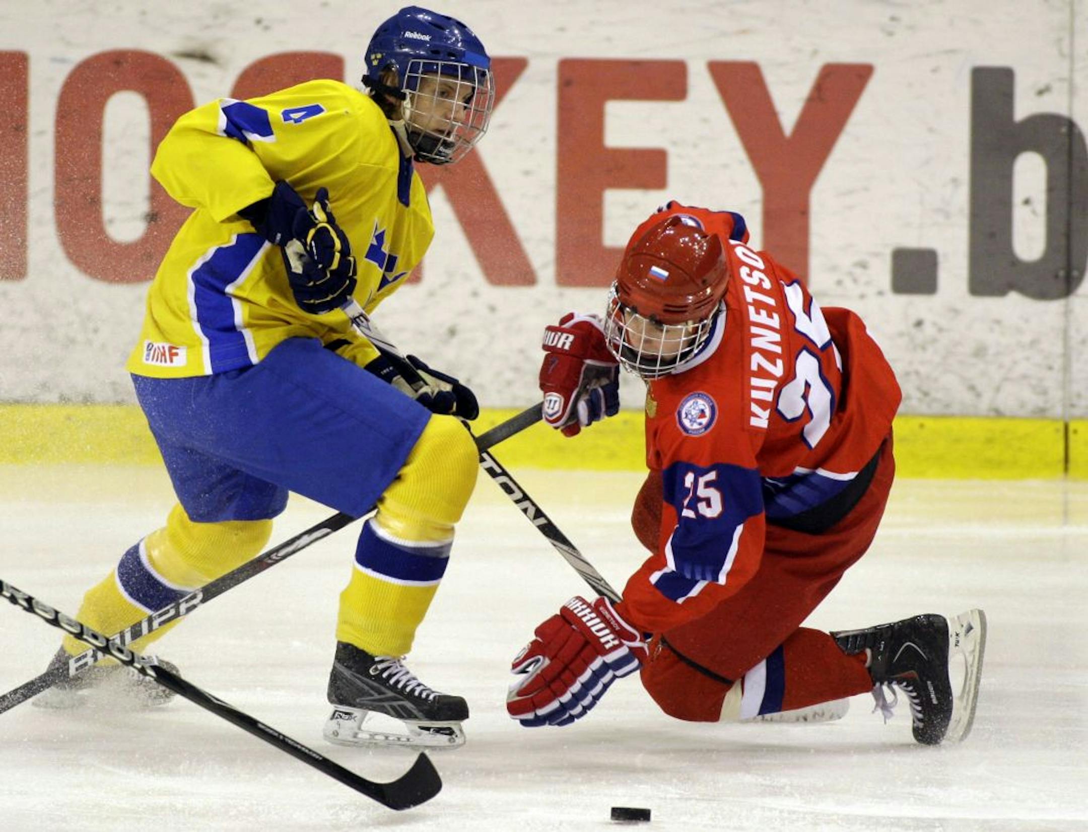 Jonas Brodin, left, of Sweden, vies for control of the puck, during the first period of an IIHF U18 Hockey World Championship game.