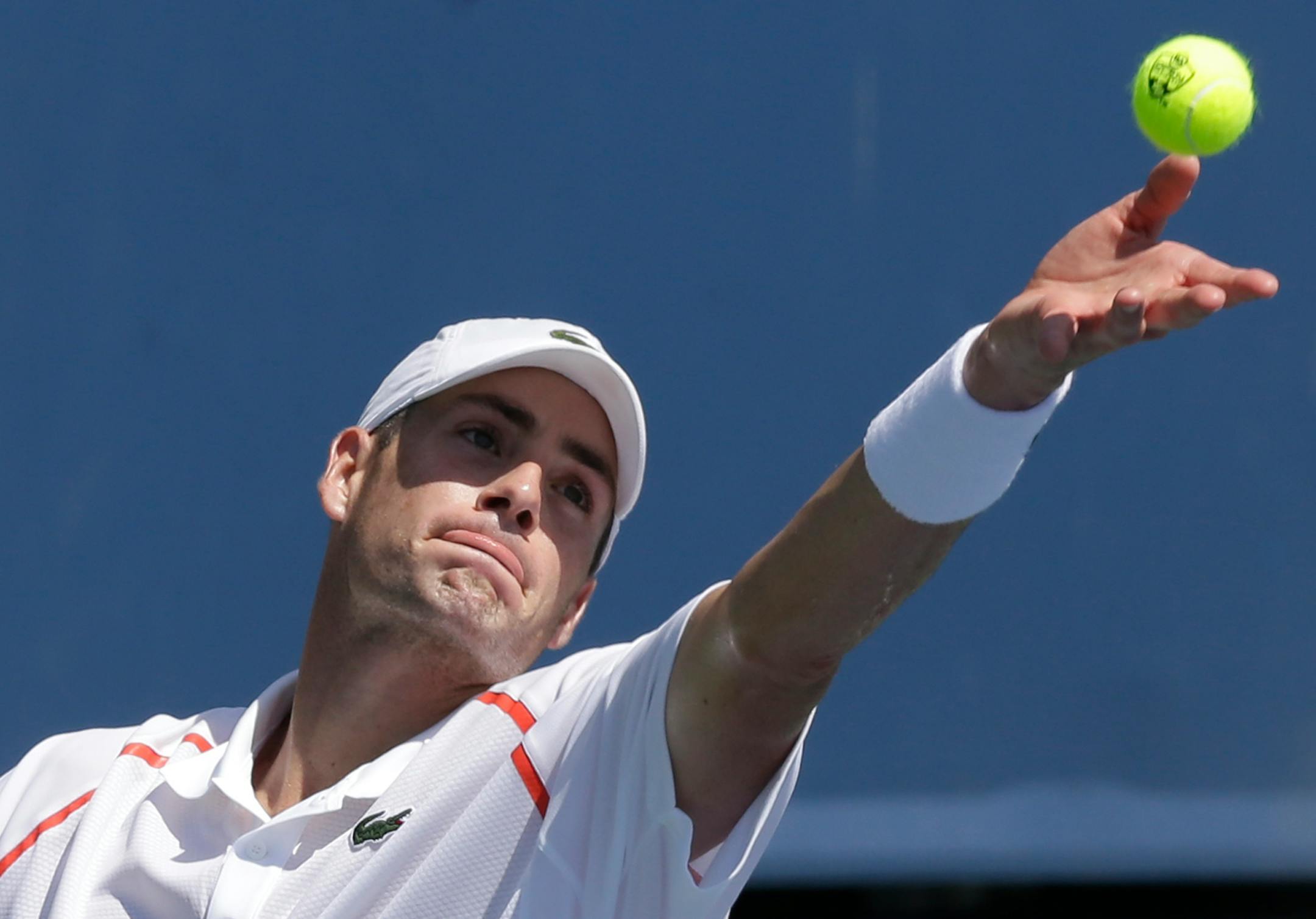 John Isner serves against Marinko Matosevic, from Australia, during a match at the Western & Southern Open tennis tournament, Wednesday, Aug. 13, 2014, in Mason, Ohio. Isner won 6-3, 7-6 (1). (AP Photo/Al Behrman)