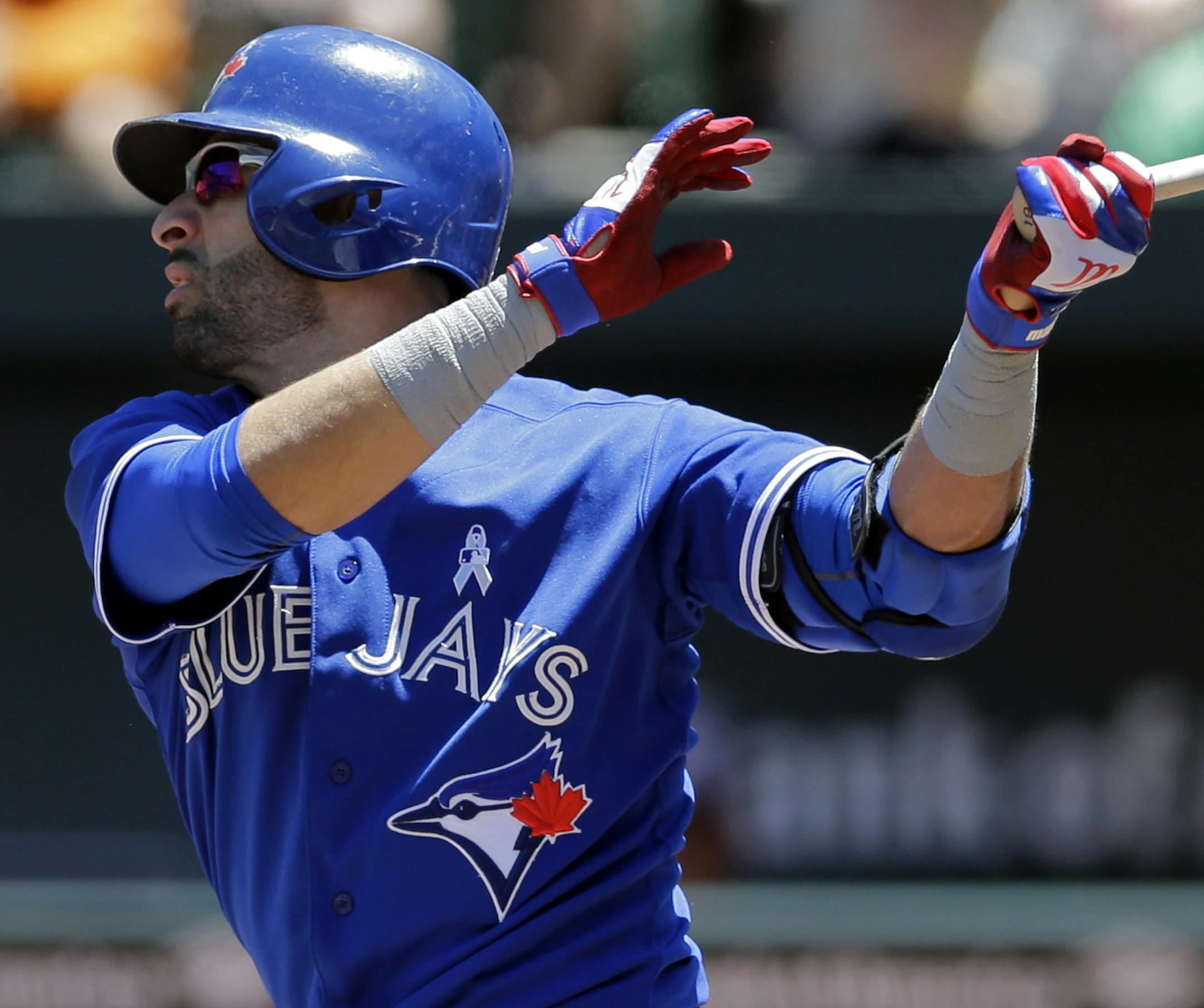Toronto Blue Jays' Jose Bautista, left, watches his double in the first inning of a baseball game against the Baltimore Orioles, Sunday, June 15, 2014, in Baltimore. Blue Jays' Jose Reyes scored on the play. (AP Photo/Patrick Semansky) ORG XMIT: MDPS101