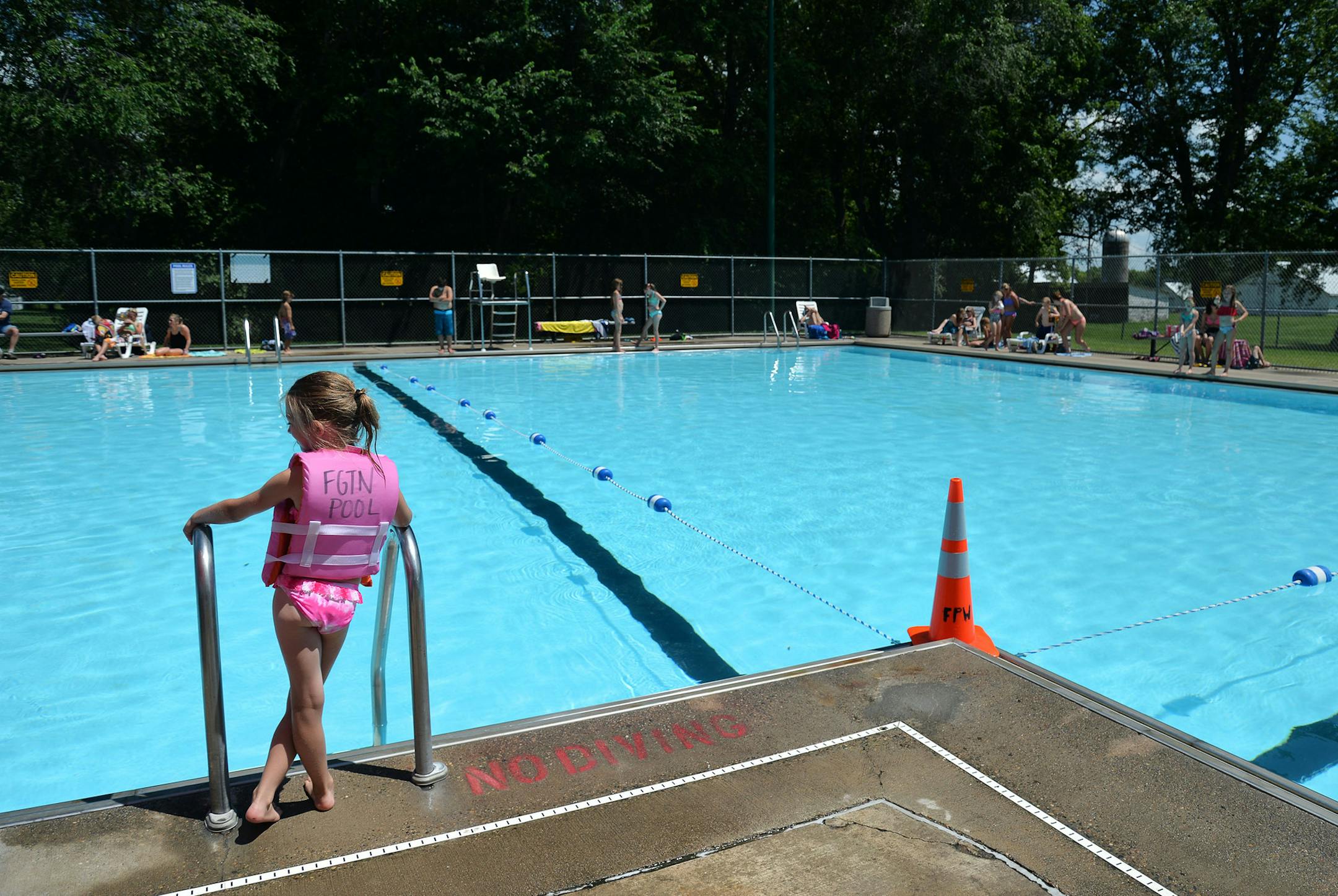 A girl stood at the edge of the pool waiting for it to reopen after a safety break. The city has discussed keeping it open until the pool’s machinery is no longer usable.