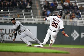 White Sox shortstop Tim Anderson reaches for a wide throw as the Twins' Max Kepler slides safely to second
