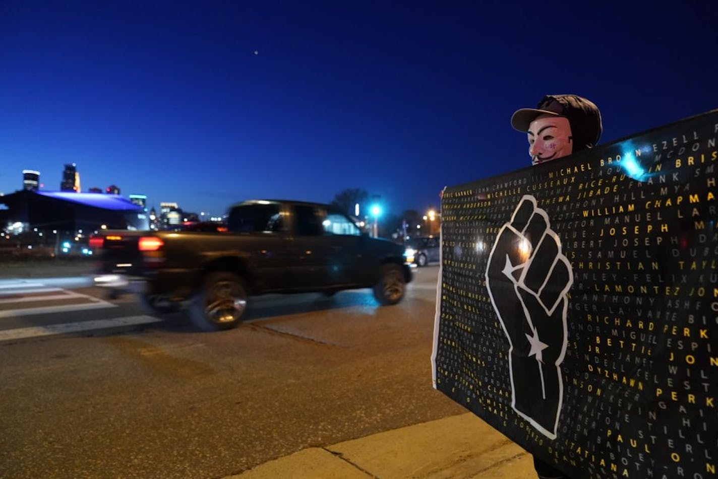 Kenner Bell of Forest Lake held a sign during the National Day of Protest rally and march Wednesday in Minneapolis.