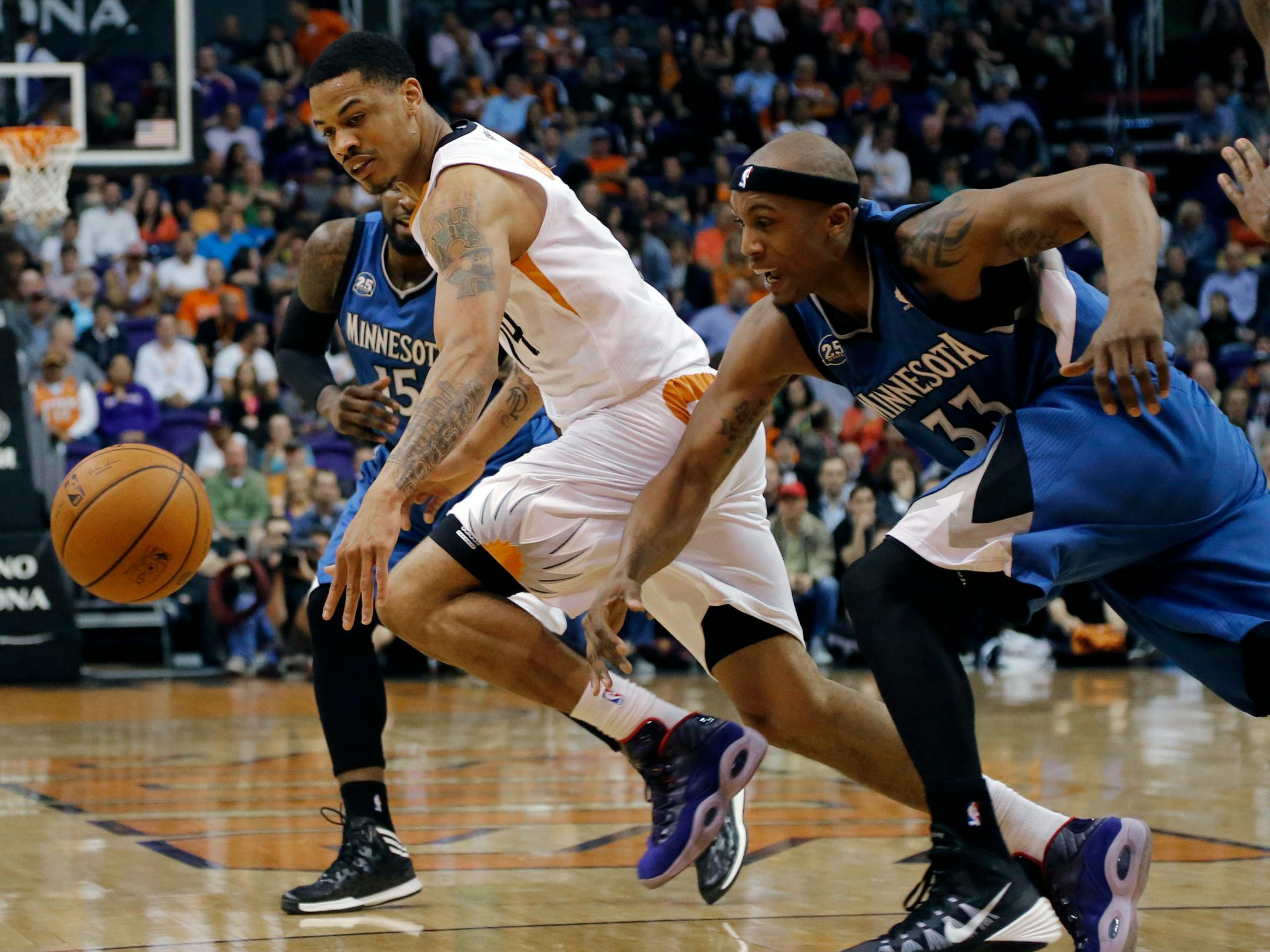 Minnesota Timberwolves forward Dante Cunningham (33) and Phoenix Suns guard Gerald Green chase down a loose ball during the first half of an NBA basketball game, Tuesday, Feb. 25, 2014, in Phoenix. (AP Photo/Matt York)