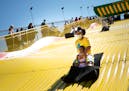 Shawnda Henderson, of Minneapolis, rode the Giant slide with her daughter Mira who was a little scared on the last day of the Kickoff to Summer at the