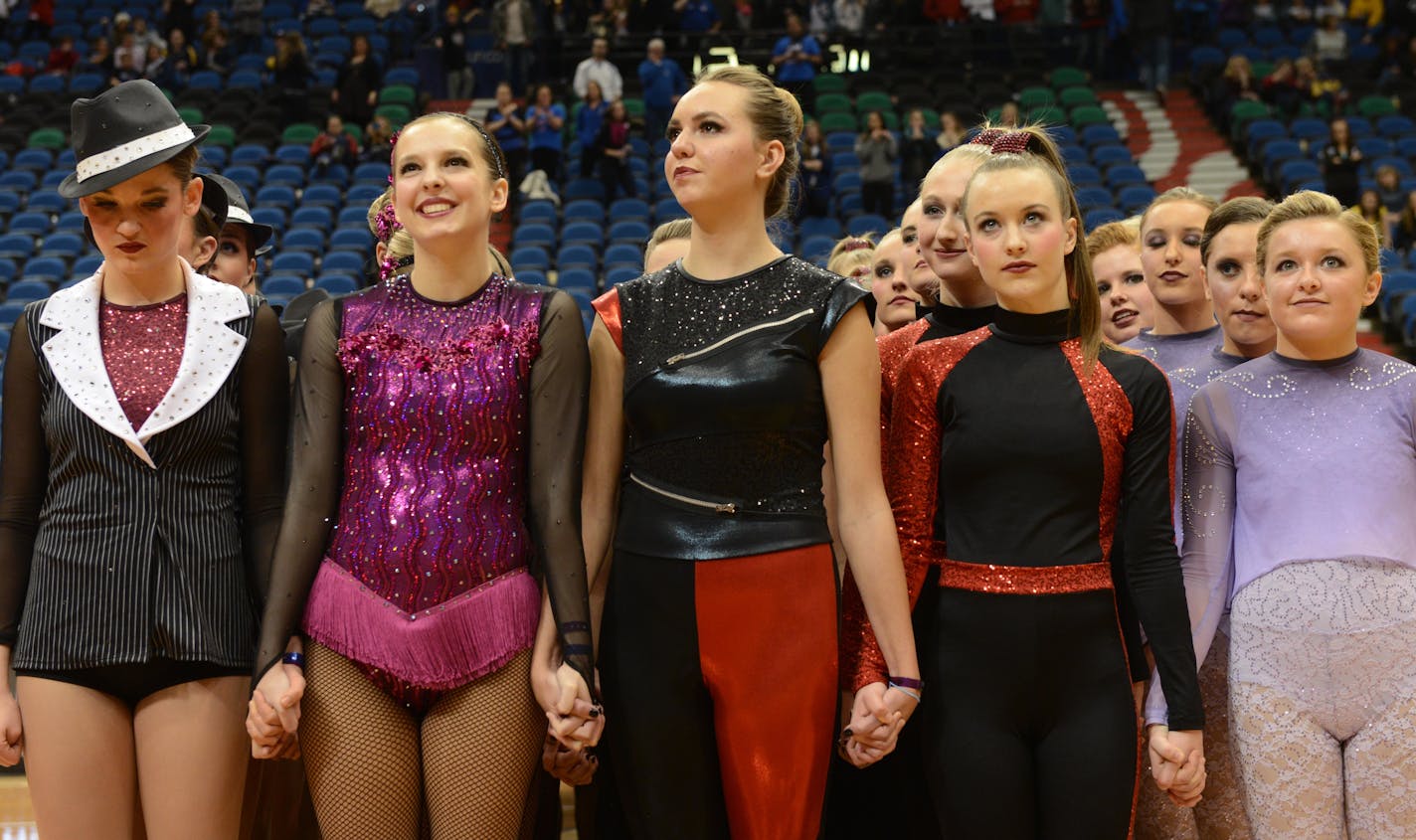 Lakeview South, Eastview, Eden Prairie, Wayzata, and Chaska dance teams all hold hands in protest prior to the announcement of awards for the 3AAA state dance team high kick division tournament in February at Target Center.