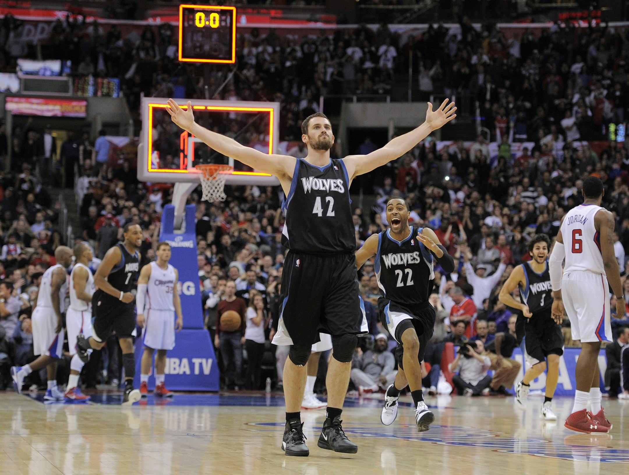 Minnesota Timberwolves forward Kevin Love (42) reacts with guard Wayne Ellington (22) after hitting a three point shot to win the game during the second half of their NBA basketball game against the Los Angeles Clippers, Friday, Jan. 20, 2012, in Los Angeles. The Timberwolves won 101-98. (AP Photo/Mark J. Terrill)