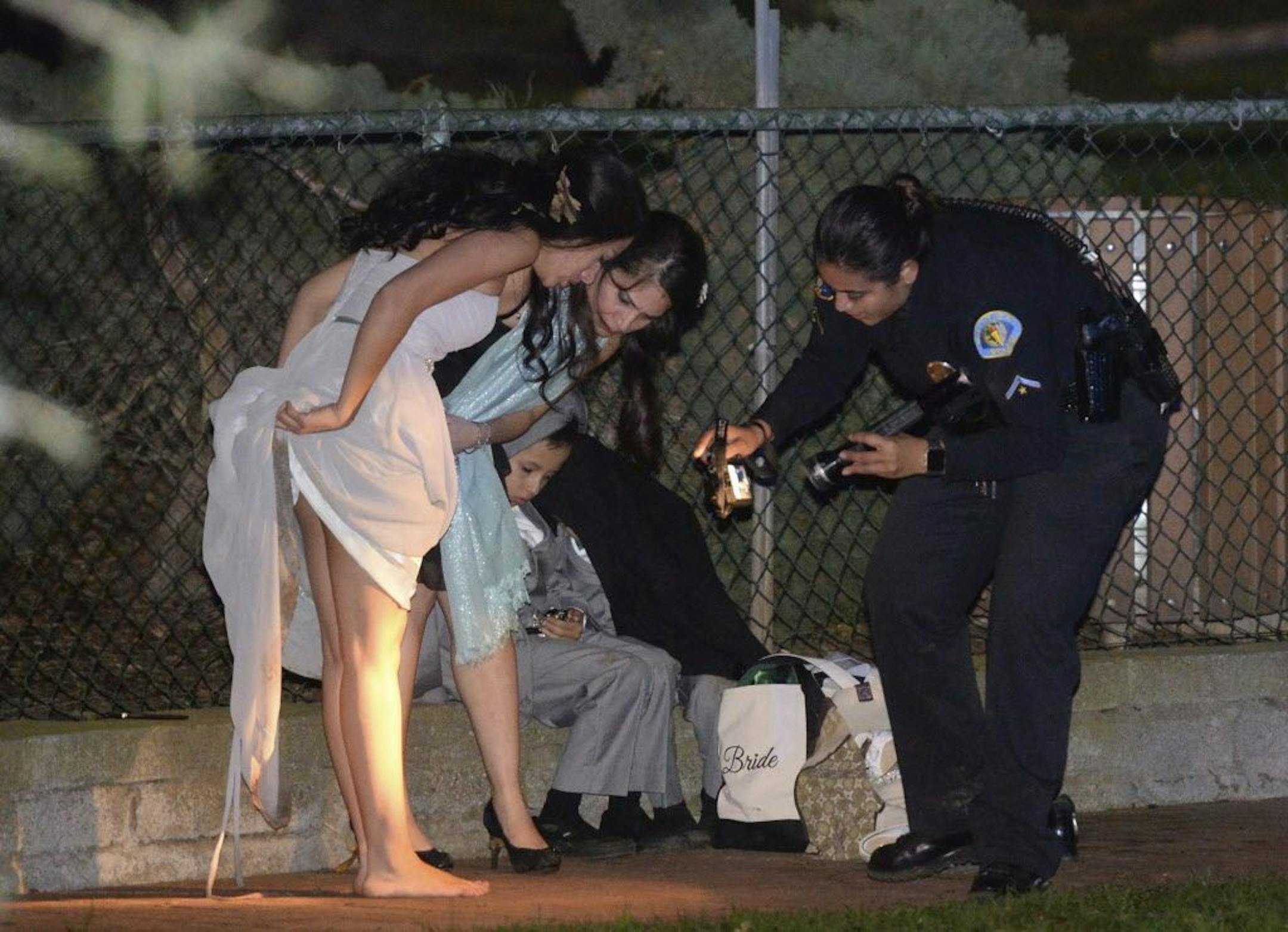 Los Angeles County Fire Dept. personnel work at the scene where a large tree fell on a wedding party in Whittier, Calif., Saturday, Dec. 17, 2016. Southern California fire officials say one person died and five people were injured after a large eucalyptus tree fell down onto a wedding party taking pictures at a park. Several people were trapped after the tree toppled Saturday in Whittier at Penn park.