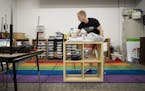 Kindergarten teacher Gus Gleiter set up his classroom on the first day back at school at Prodeo Academy in Minneapolis, Minn., on August 1, 2018. ] RE