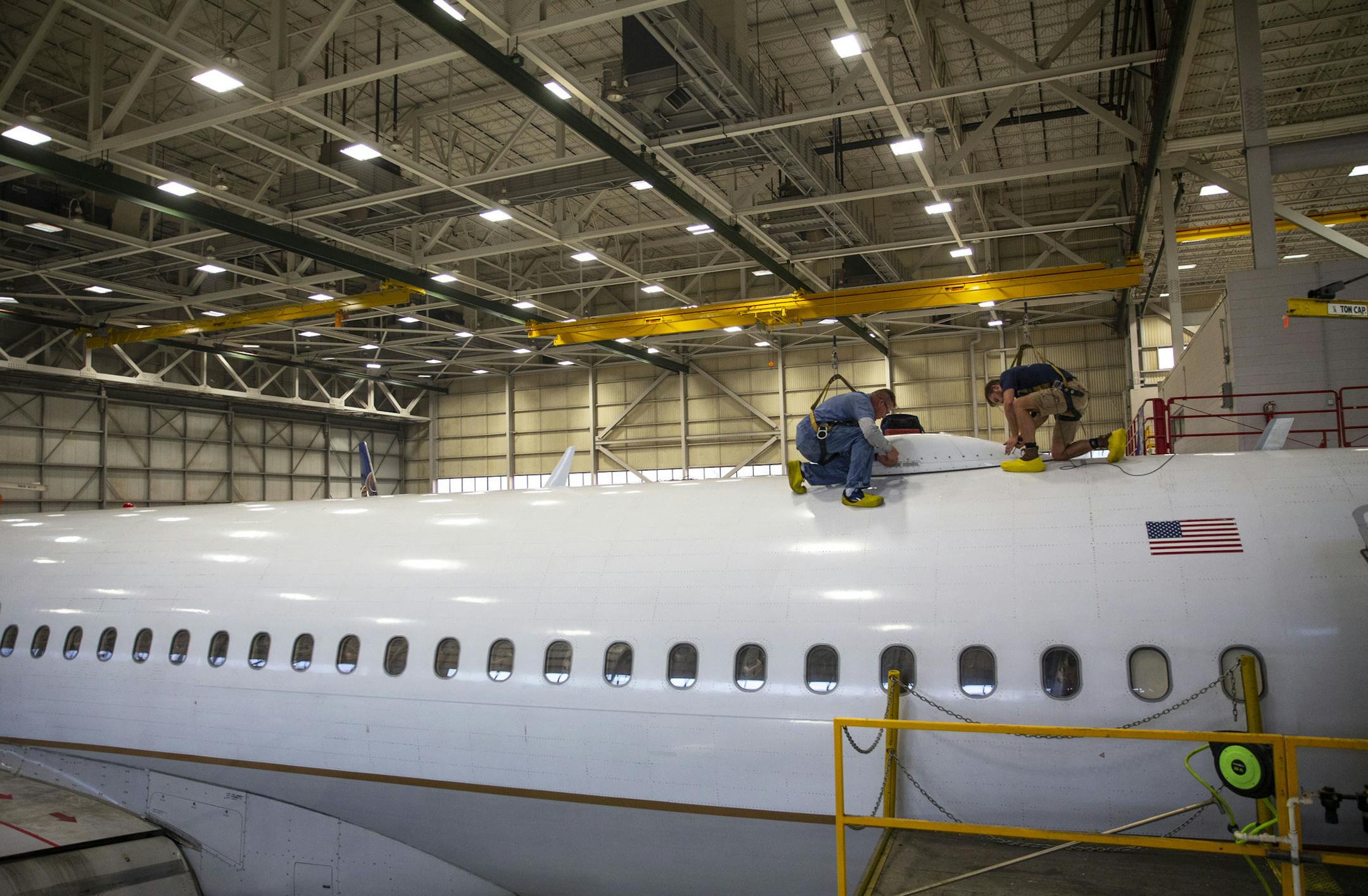FILE-Two mechanics work on an a commercial airplane at AAR Corp. in September 2019. Duluth is seeking a settlement with the company after it closed its hangar here this spring. ALEX KORMANN • alex.kormann@startribune.com