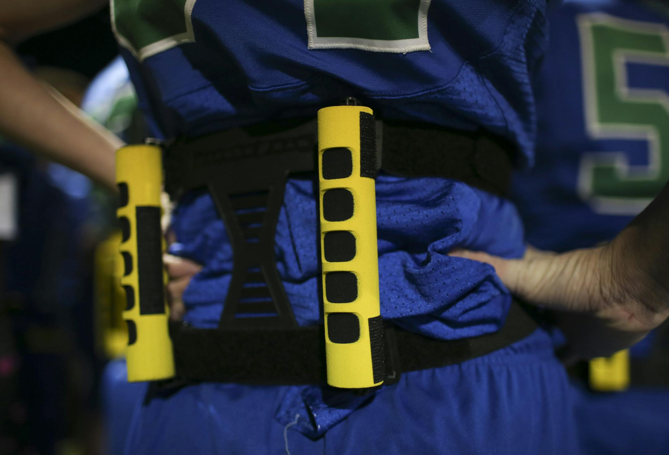 Detail of the pair of bars on a Blake player's back Monday night. ] JEFF WHEELER &#xef; jeff.wheeler@startribune.com The IMAC Conference has begun an initiative to help bring back football to the schools called Fusion Football. It's for middle schoolers and it's basically modified flag football using helmets and shoulder pads. There is no tackling and minimal contact while teaching proper technique so kids are prepared for tackle football when they reach high school. Blake hosted Providence Acad