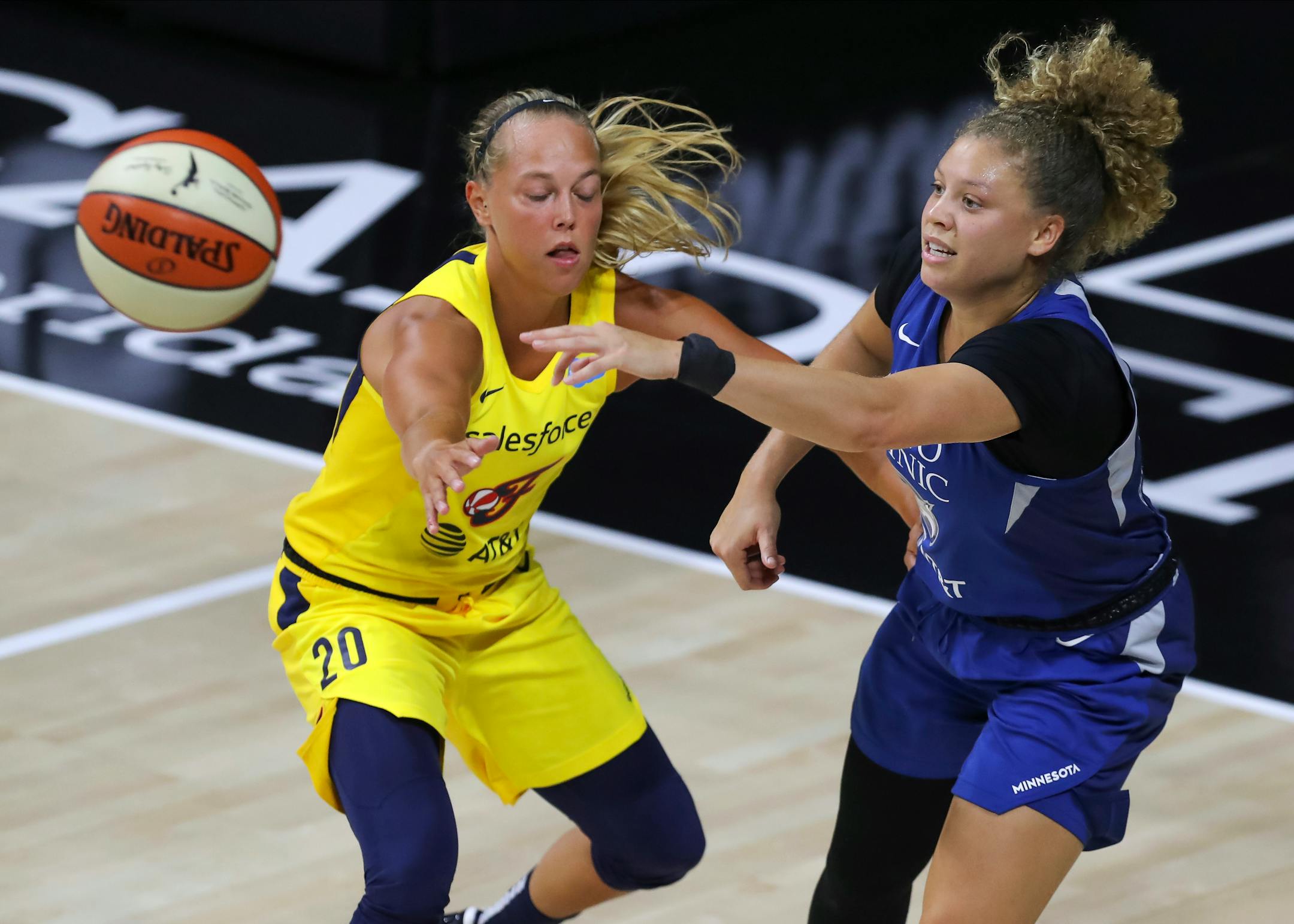 Rachel Banham, right, passes the ball past Indiana's Julie Allemand during the first half