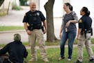 Licensed clinical social worker Kara Haroldson, center, stood with officers Justin Tiffany and Lori Goulet as they checked the well being of a man sle