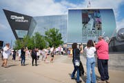 Fans wait for doors to open for the first of two Taylor Swift concerts during the Eras Tour outside U.S. Bank Stadium in Minneapolis, Minn., on Friday