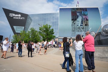 Fans wait for doors to open for the first of two Taylor Swift concerts during the Eras Tour outside U.S. Bank Stadium in Minneapolis, Minn., on Friday