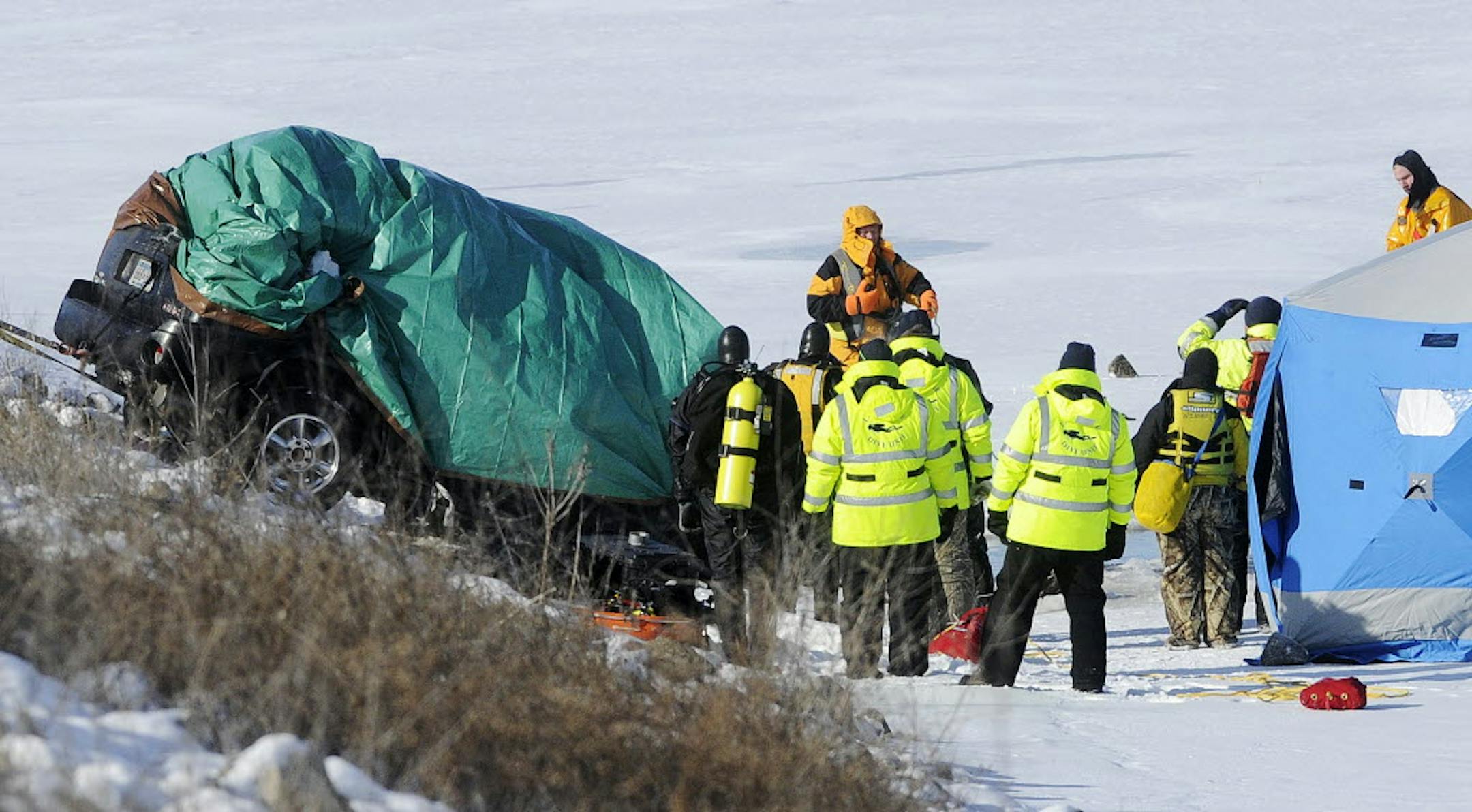 A vehicle is pulled from the Mississippi River on Riverview Drive near Huff Street in Winona, Minn., on Sunday, Jan. 5, 2014. Two bodies were recovered from the vehicle.