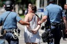 A protester was taken into custody near the governor’s residence in July in St. Paul.