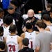 Louisville coach Chris Mack, center, talks with his team during the first half against Duke in the second round of the Atlantic Coast Conference tourn