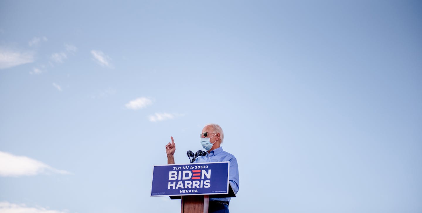 FILE -- Joe Biden, the Democratic presidential nominee, addresses a drive-in campaign event at Southeast Career Technical Academy in Las Vegas, Oct. 9, 2020. If elected, Biden and his allies are preparing to pass climate change legislation, piece by piece — knowing full well that the candidate's $2 trillion plan would be a tough sell. (Hilary Swift/The New York Times)