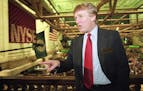 File-This June 7, 1995, file photo shows real estate magnate Donald Trump posing for photos above the floor of the New York Stock Exchange after takin