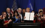 President Donald Trump gestures after signing an executive order to tighten the rules for technology companies seeking to bring highly skilled foreign