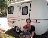 photo of woman and child with camper
