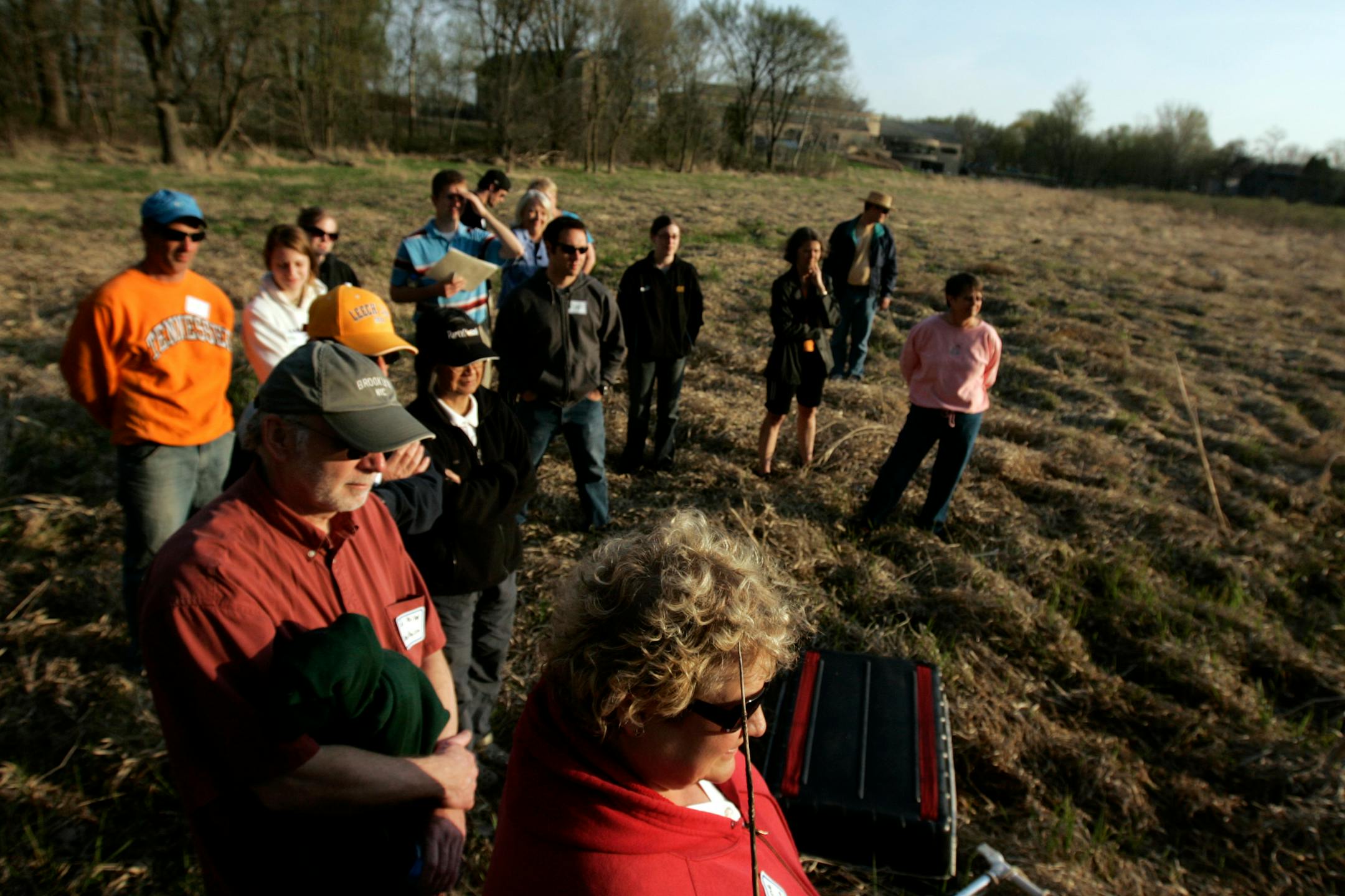 Volunteers are sent in to the field wearing hip boots and bearing such equipment as nets and bottle traps that will help them take measurements and observations of water organisms and plant life.